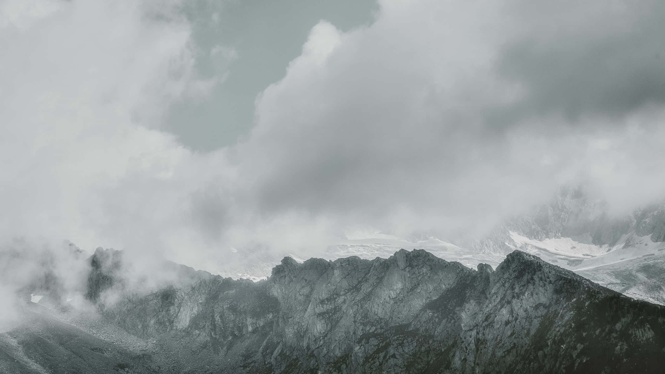 Cool Gray, misty clouds, jagged snowcapped mountain peaks, 2K Desktop Wallpaper