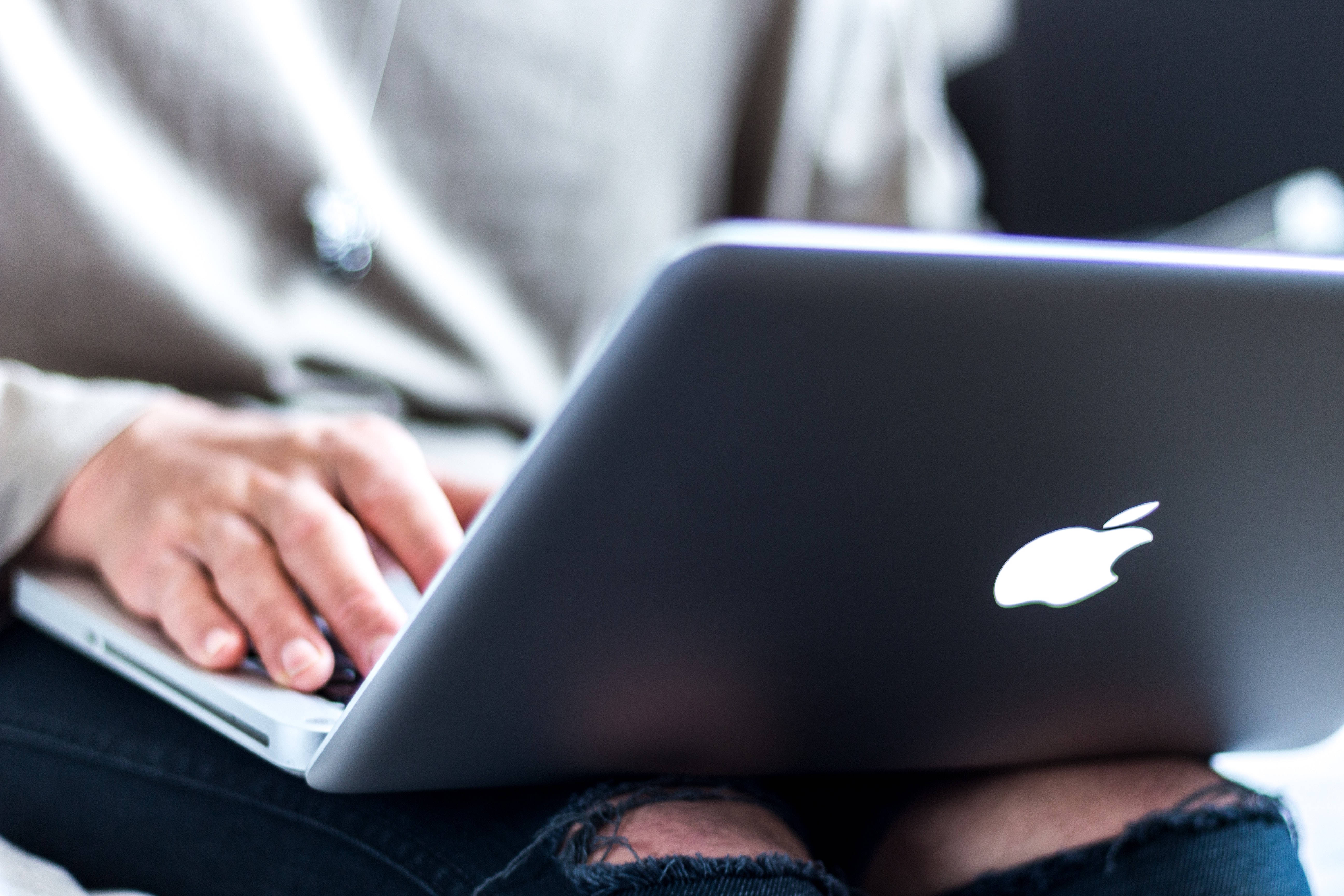 silver laptop, ripped jeans, soft blurred background, 5K Desktop Wallpaper