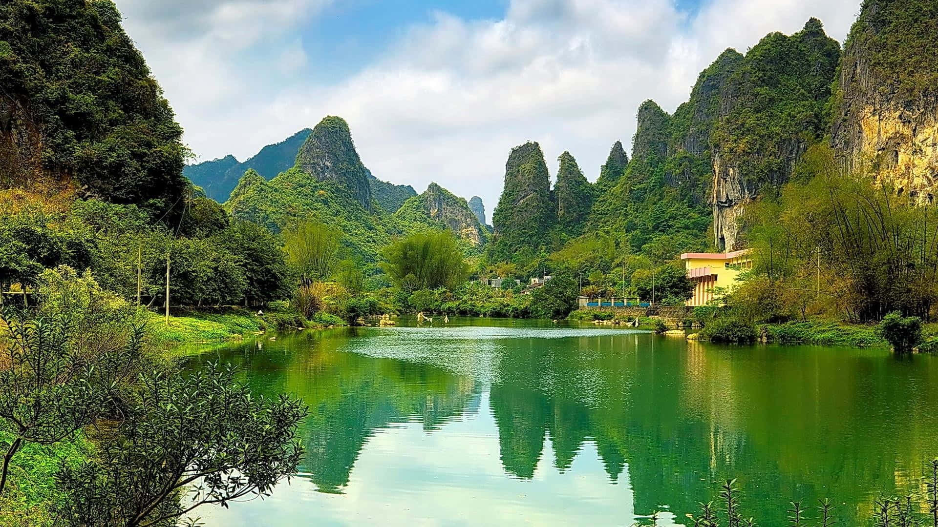 serene lake, lush green karst mountains, partly cloudy sky, Full HD Desktop Wallpaper