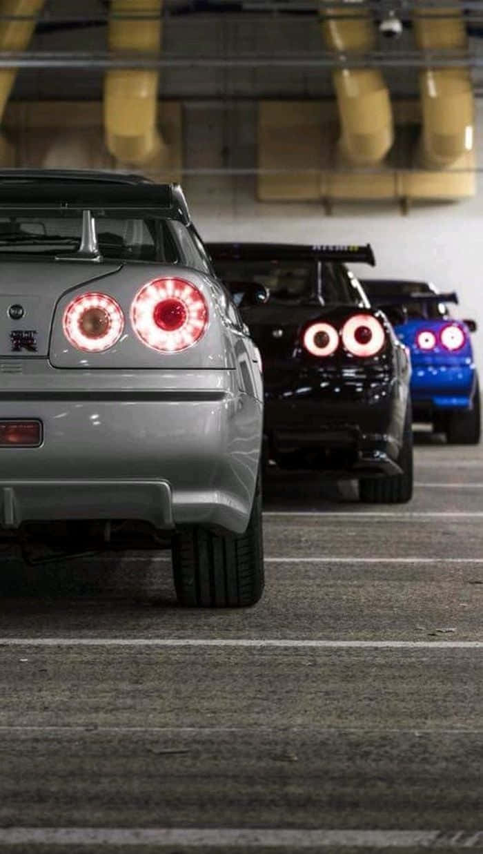 Nissan Skyline, glowing circular taillights, dimly lit underground garage, SD Phone Wallpaper