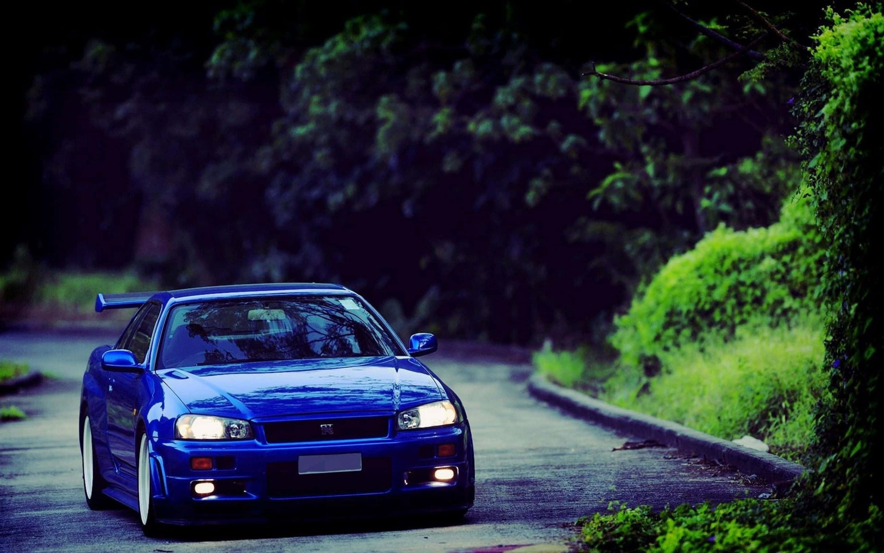 Nissan Skyline, vibrant blue, glowing headlights, 2K Desktop Wallpaper
