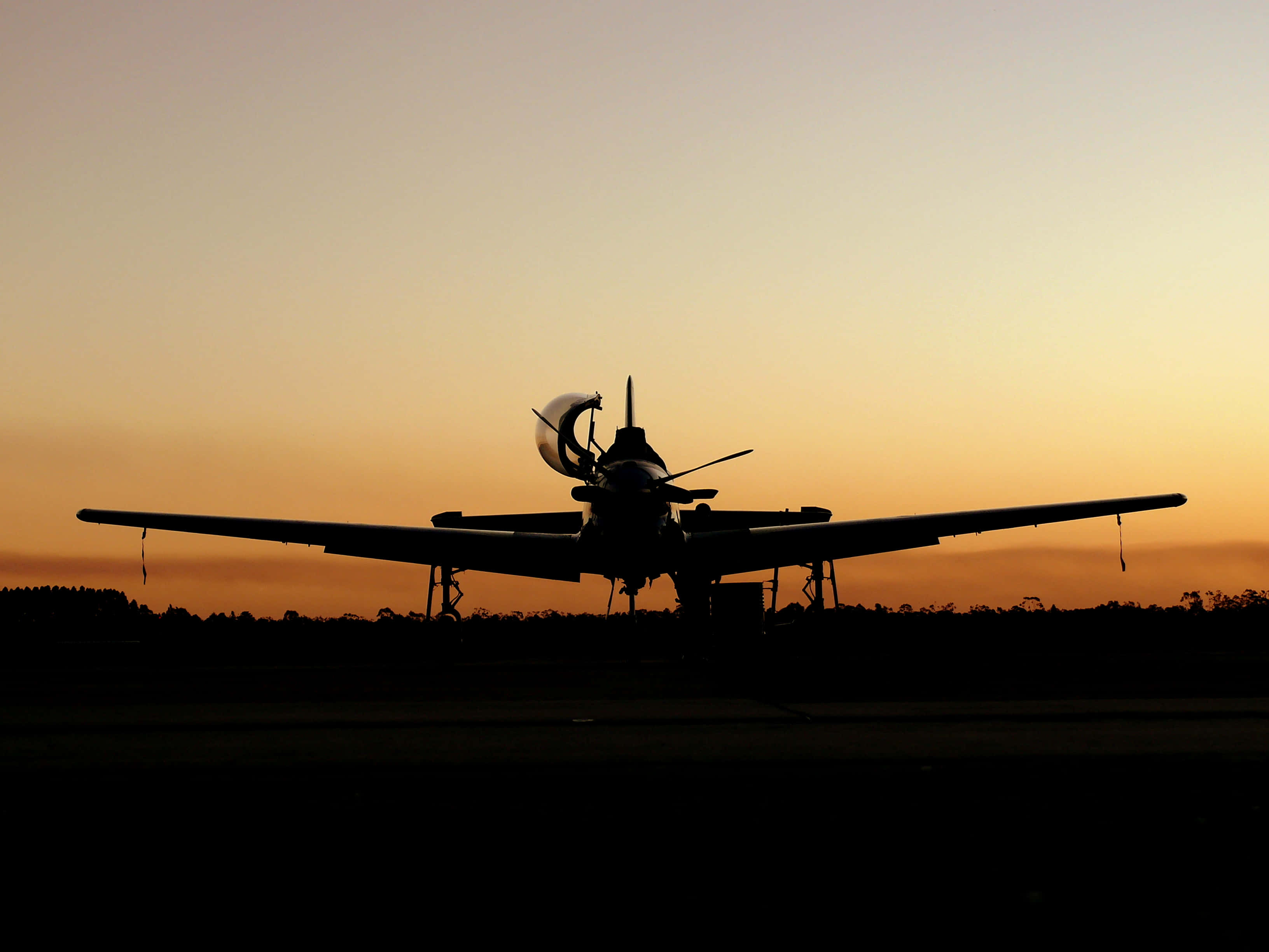 vintage propeller plane, runway, warm orange sunset sky, 2K Desktop Wallpaper