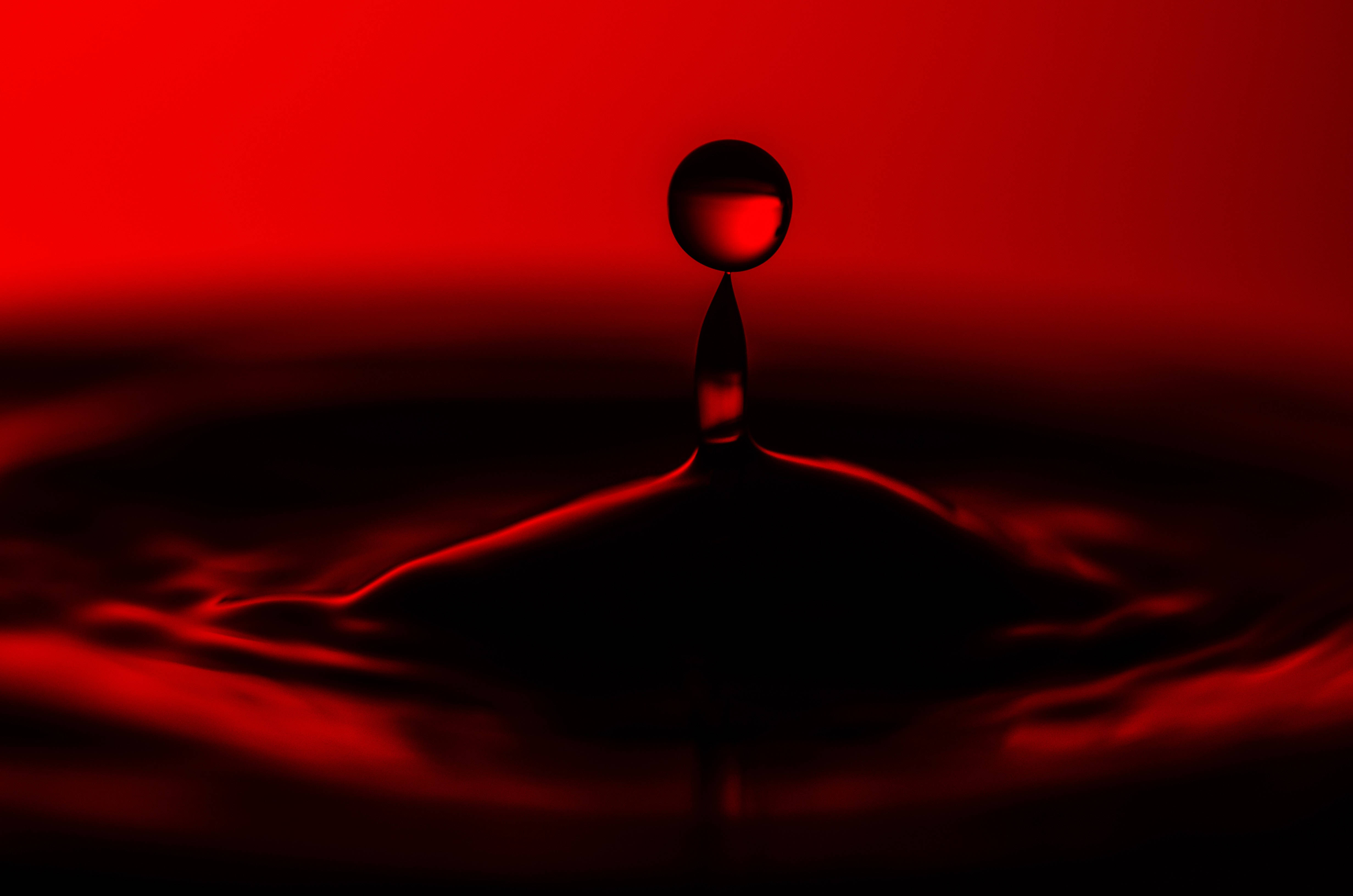 red droplet, rippling pool of liquid, deep crimson gradient background, 4K Desktop Wallpaper