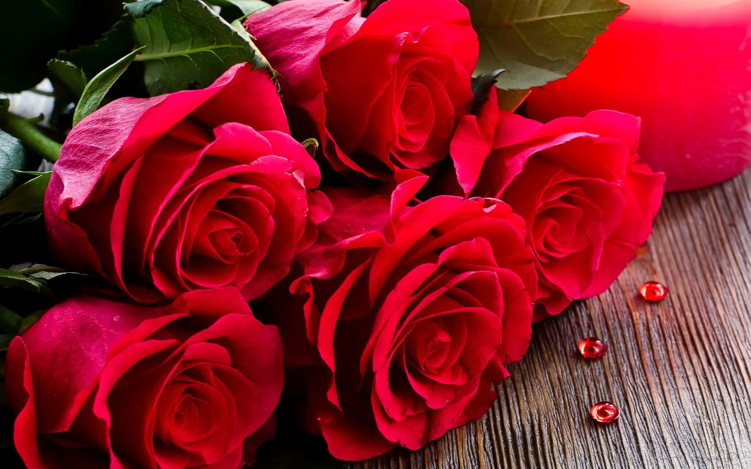 vibrant red roses, dew drops, rustic wooden surface, 2K Desktop Wallpaper