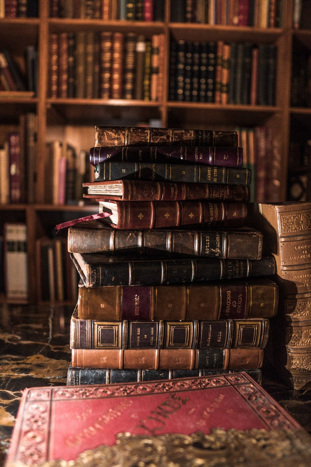 vintage leather-bound books, marble table, bookshelf, HD Phone Wallpaper