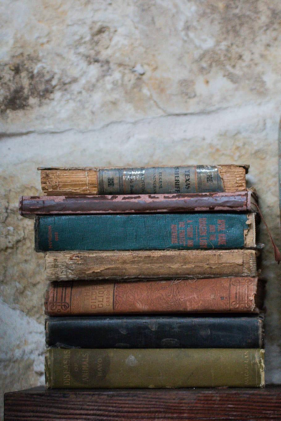 vintage books, peeling spines, rough stone wall, HD Phone Wallpaper