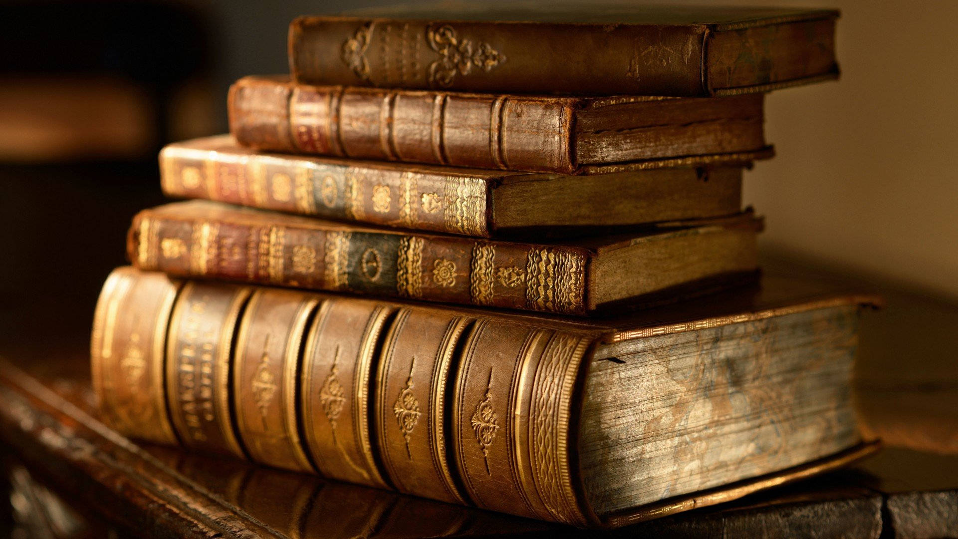 vintage leather-bound books, gold embossing, wooden surface, Full HD Desktop Wallpaper