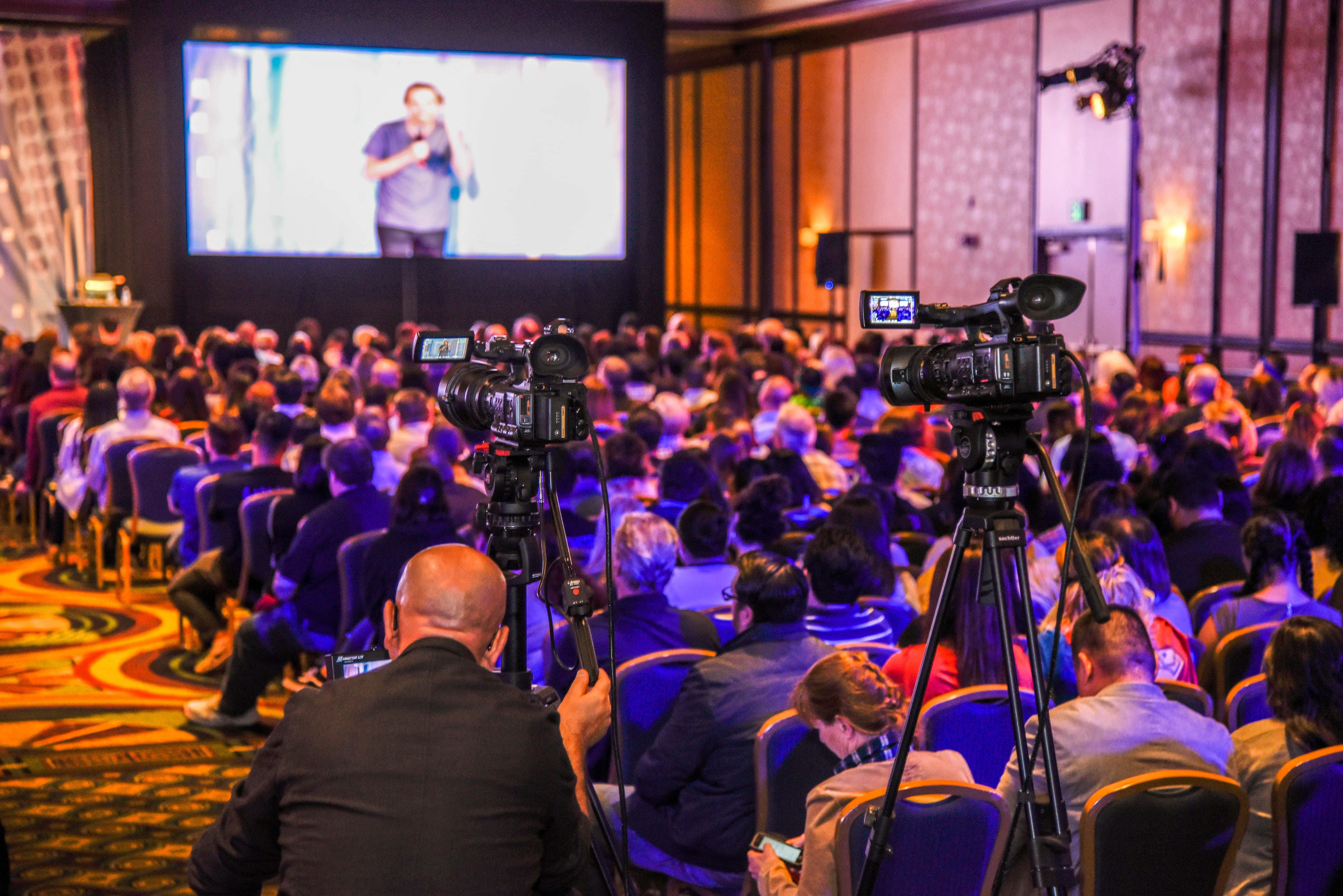 corporate event, city skyline, speaker on stage, 5K Desktop Wallpaper