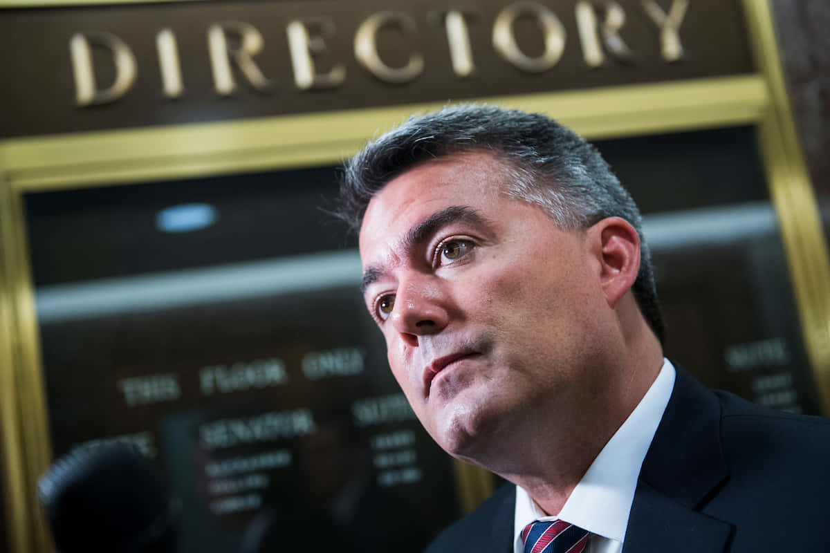 Cory Gardner, suit and tie, golden directory sign, SD Desktop Wallpaper