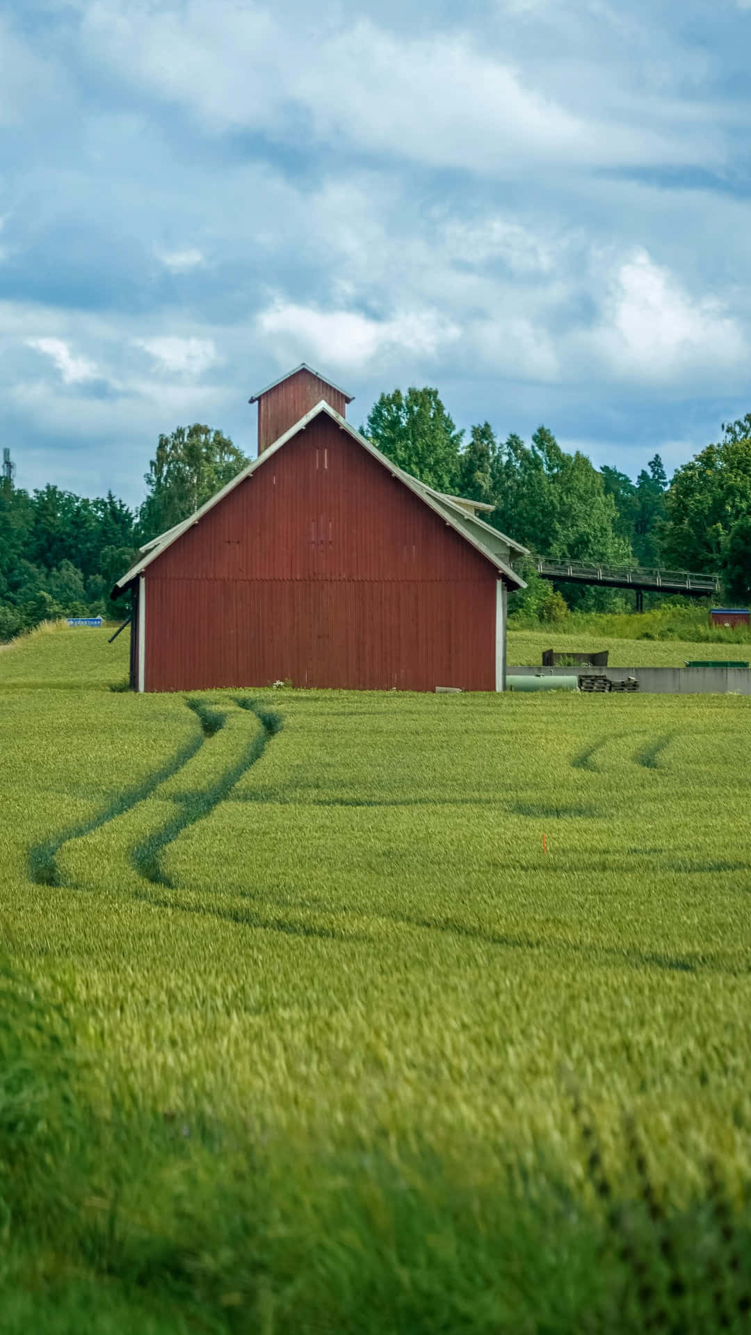 red barn, vibrant green wheat field, cloudy sky, Full HD Phone Wallpaper