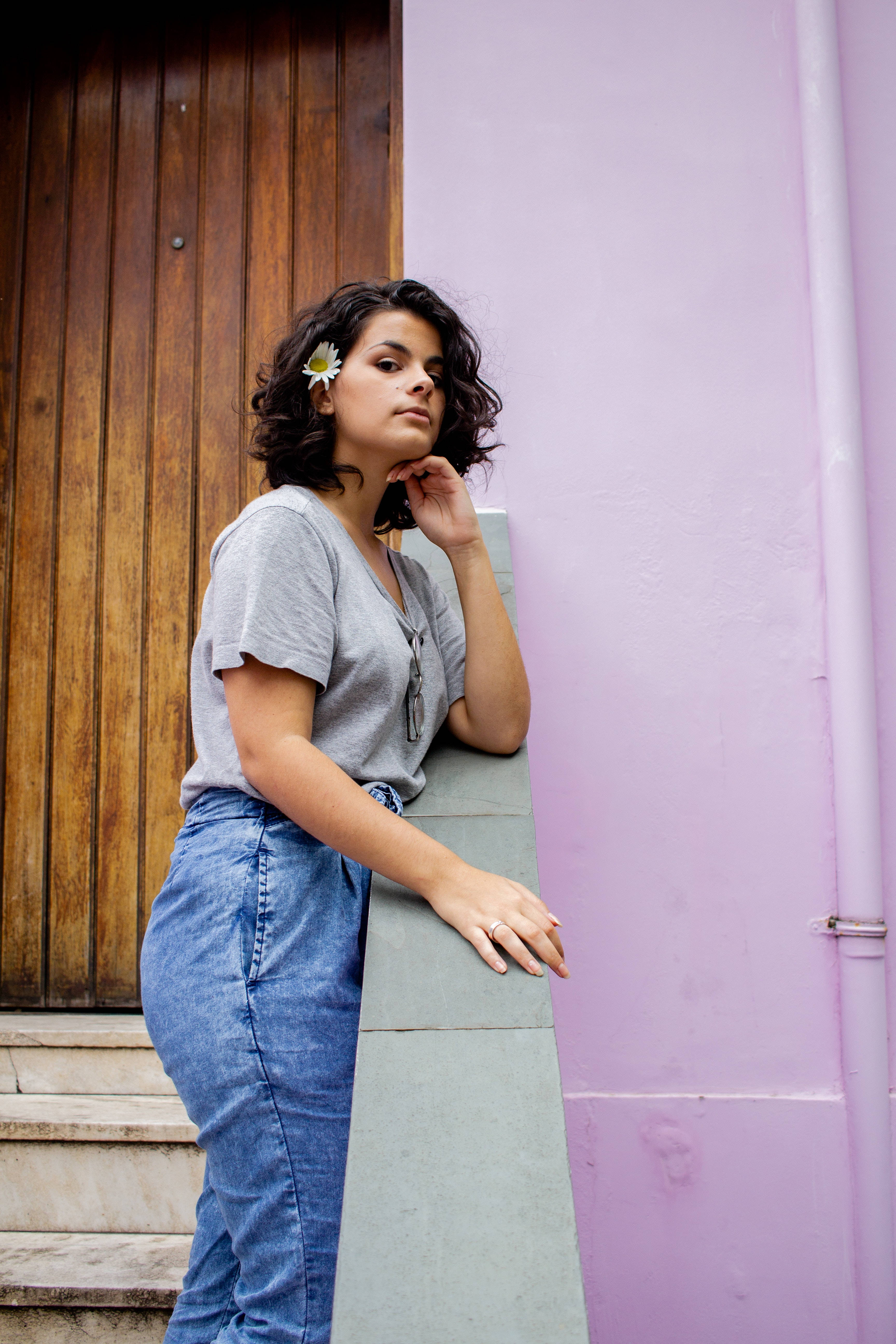 Latina Girl, daisy in her hair, lavender wall, 5K Phone Wallpaper