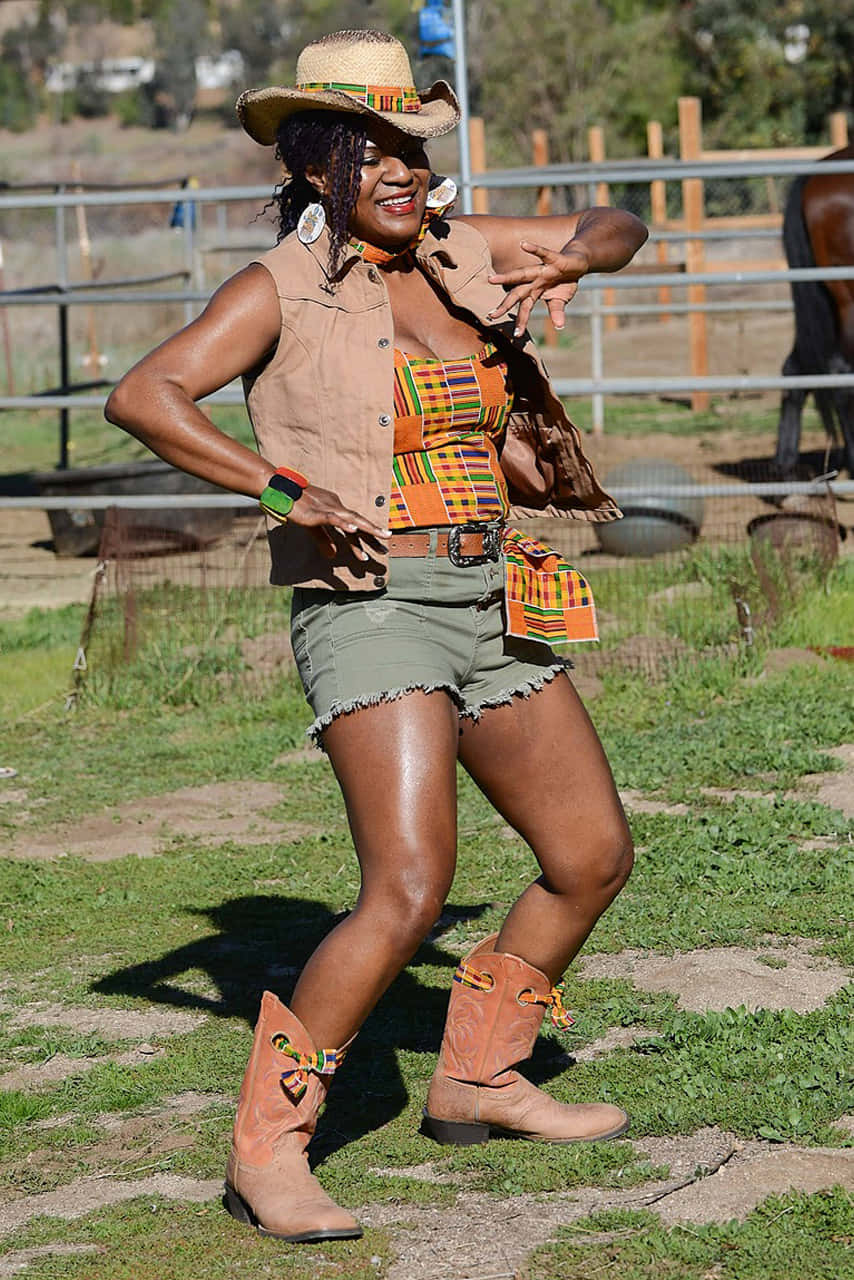 Kente-patterned attire, cowboy boots, sunlit fenced pasture, HD Phone Wallpaper