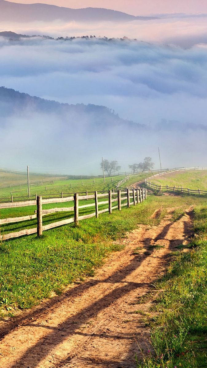 Country iPhone, dirt path, misty green hills, SD Phone Wallpaper