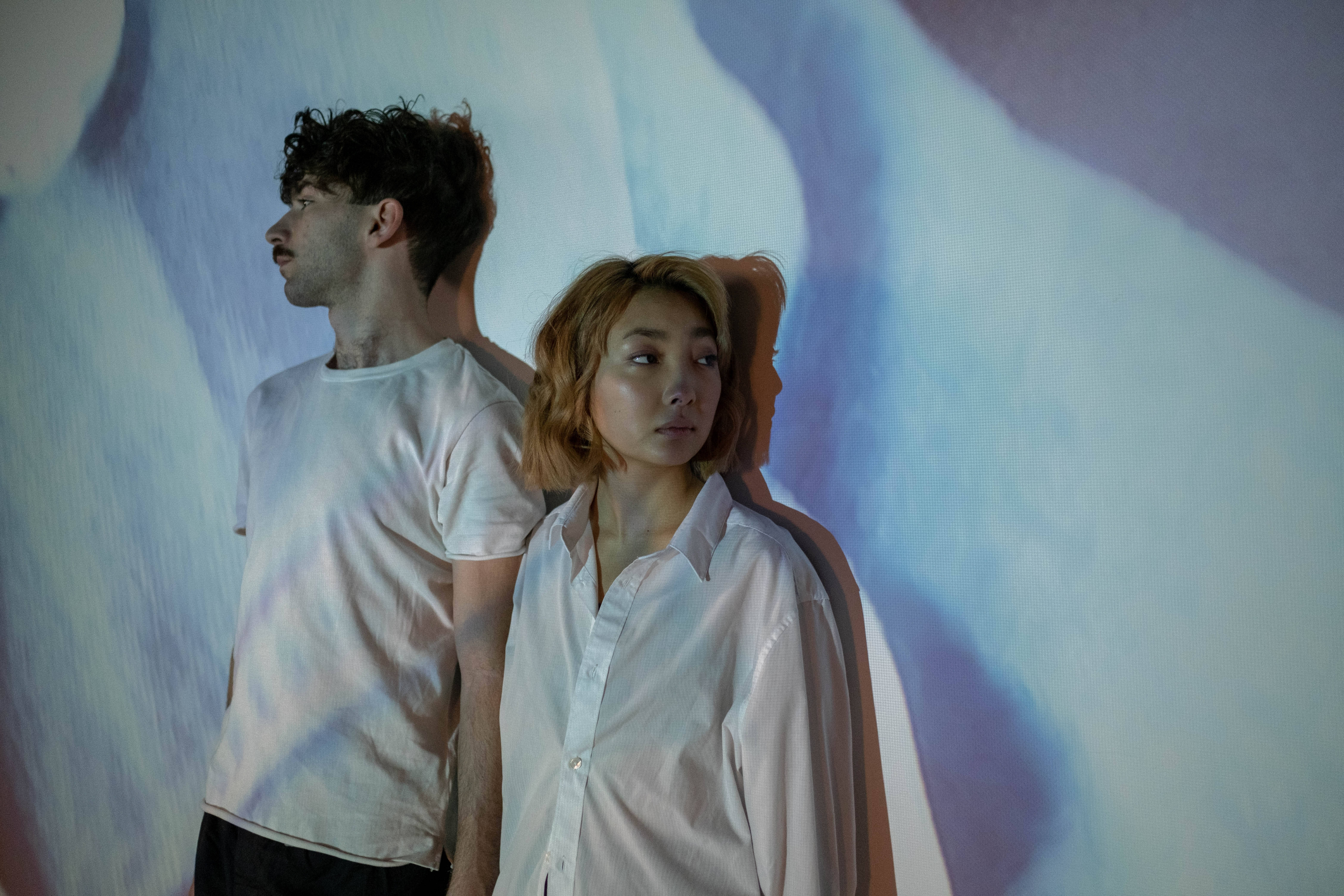 abstract wall projection, cool tones, two people, 5K Desktop Wallpaper