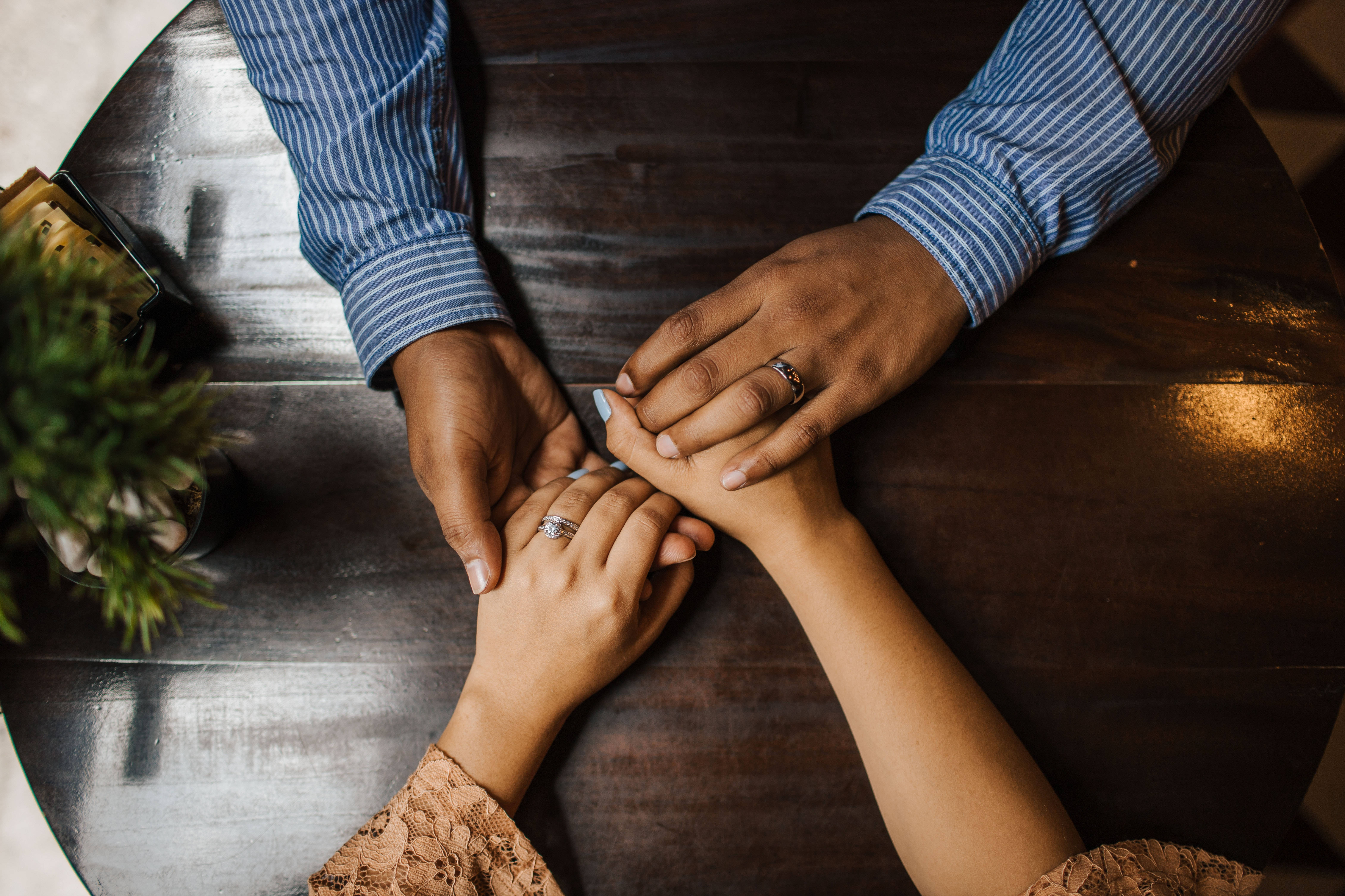 Couple Hands, top view, dark wooden table, 5K Desktop Wallpaper