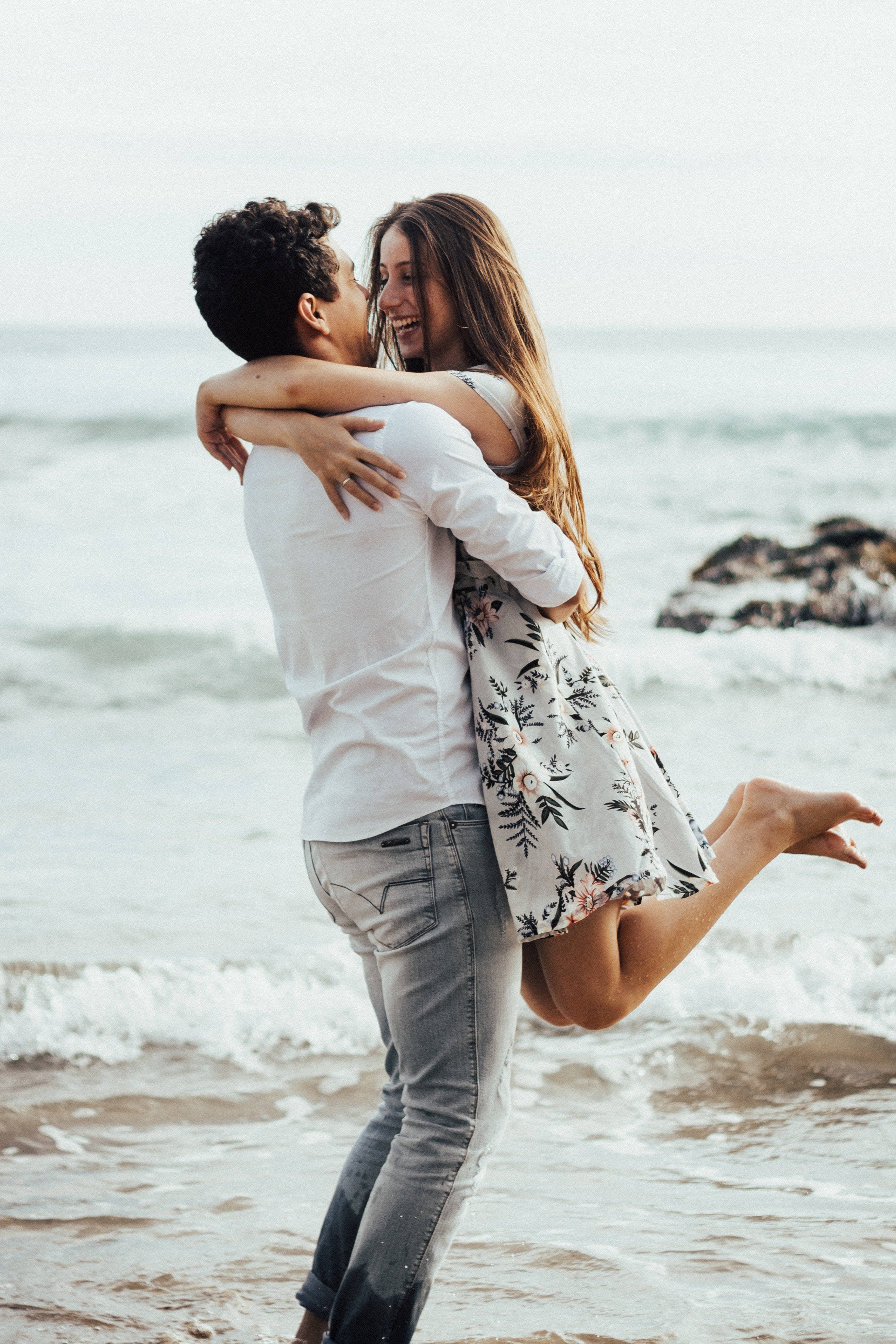 couple in love, man lifting woman, sunlit beach, 4K Phone Wallpaper
