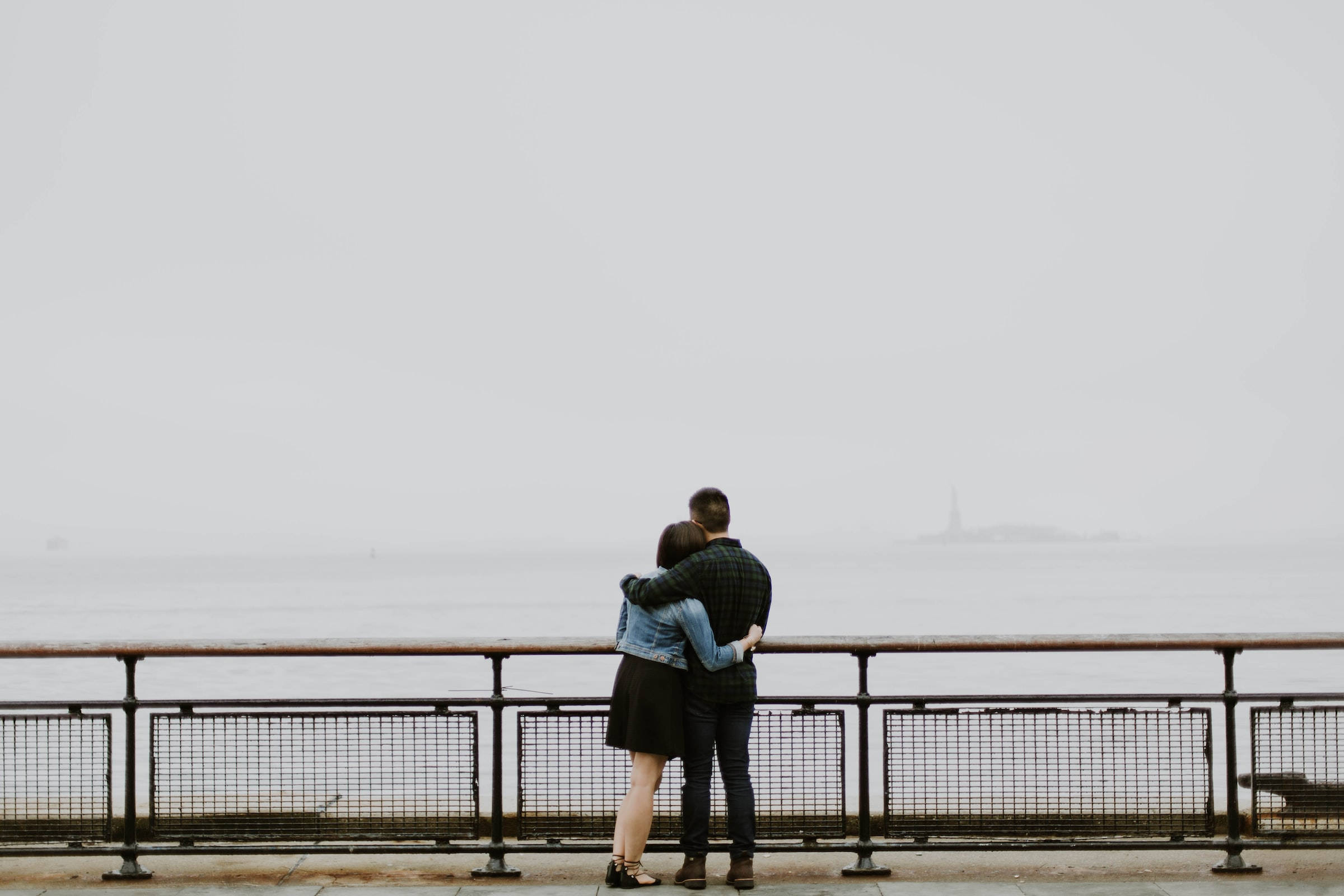 couple hugging, foggy waterfront pier, distant lighthouse, Full HD Desktop Wallpaper