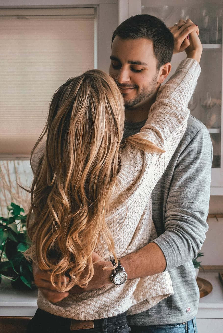 affectionate couple hugging, sunlit kitchen, soft natural light, HD Phone Wallpaper