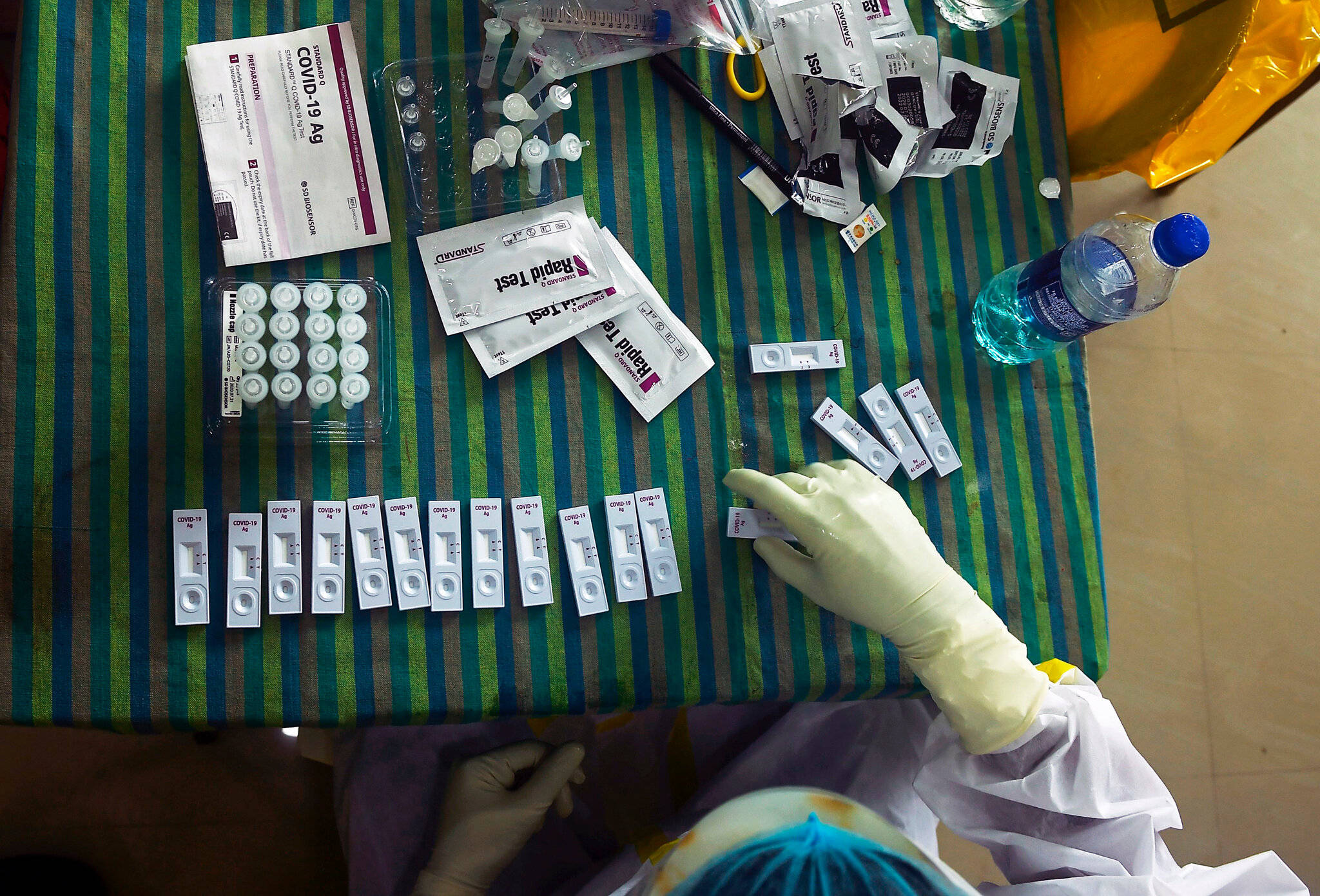 COVID-19 rapid test kits, gloved hand, striped green and blue tablecloth, Full HD Desktop Wallpaper