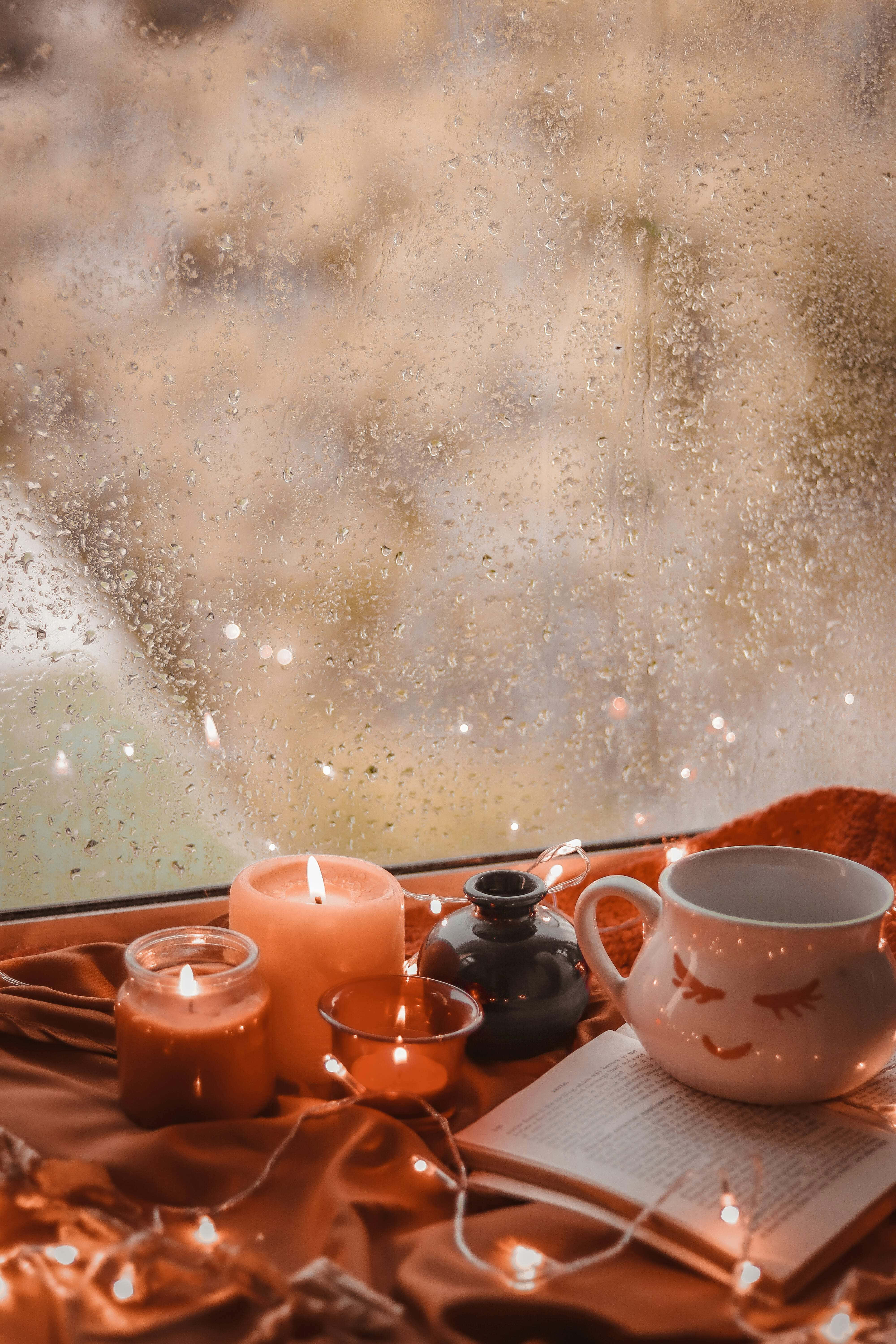 cozy autumn window scene, lit candles, string lights, 5K Phone Wallpaper