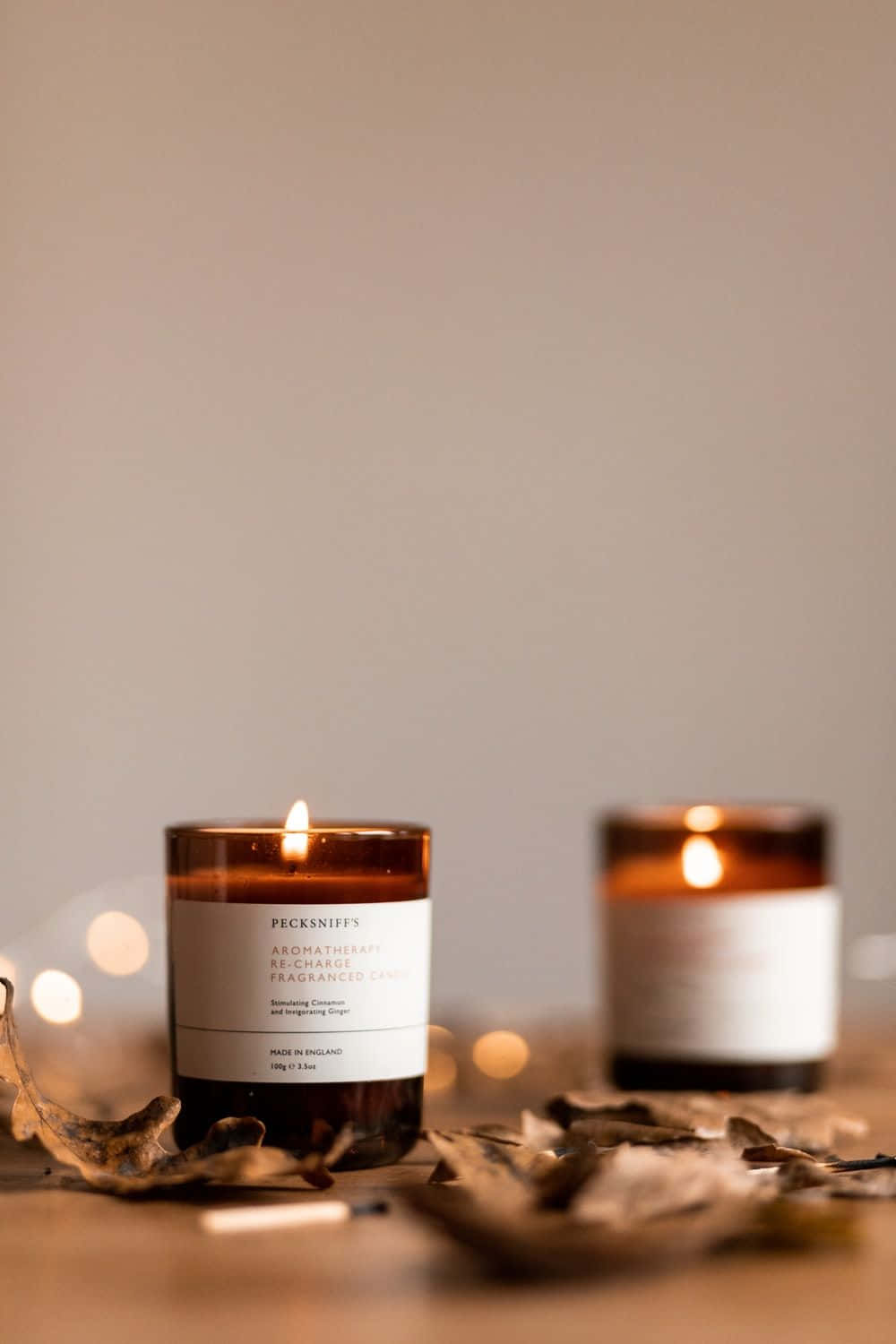 amber glass candles, wooden surface, dried leaves, HD Phone Wallpaper