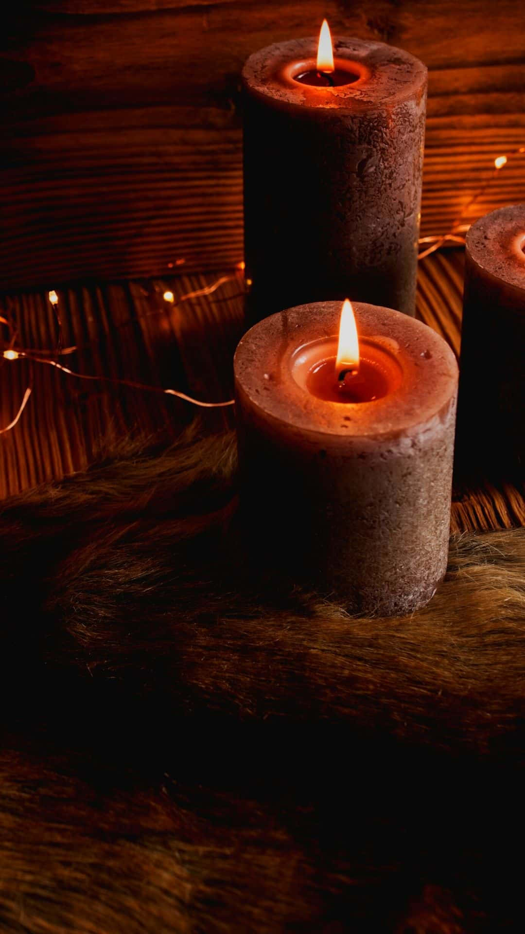 three candles, wooden table, furry surface, Full HD Phone Wallpaper
