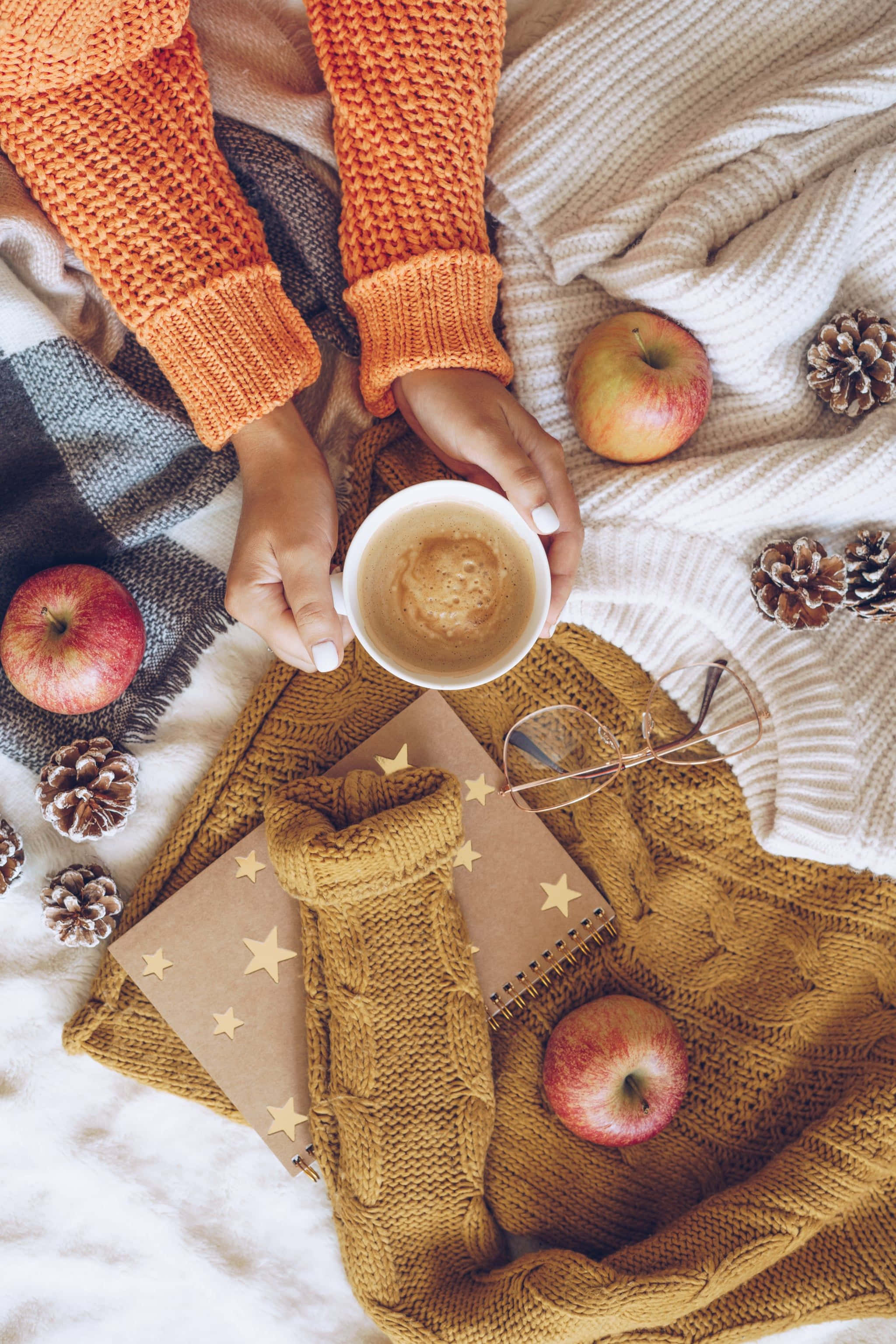 Cozy iPhone, autumn scene, hands holding coffee cup, 2K Phone Wallpaper