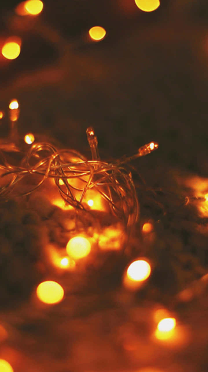 Cozy iPhone, golden fairy lights, dark blurred background, HD Phone Wallpaper