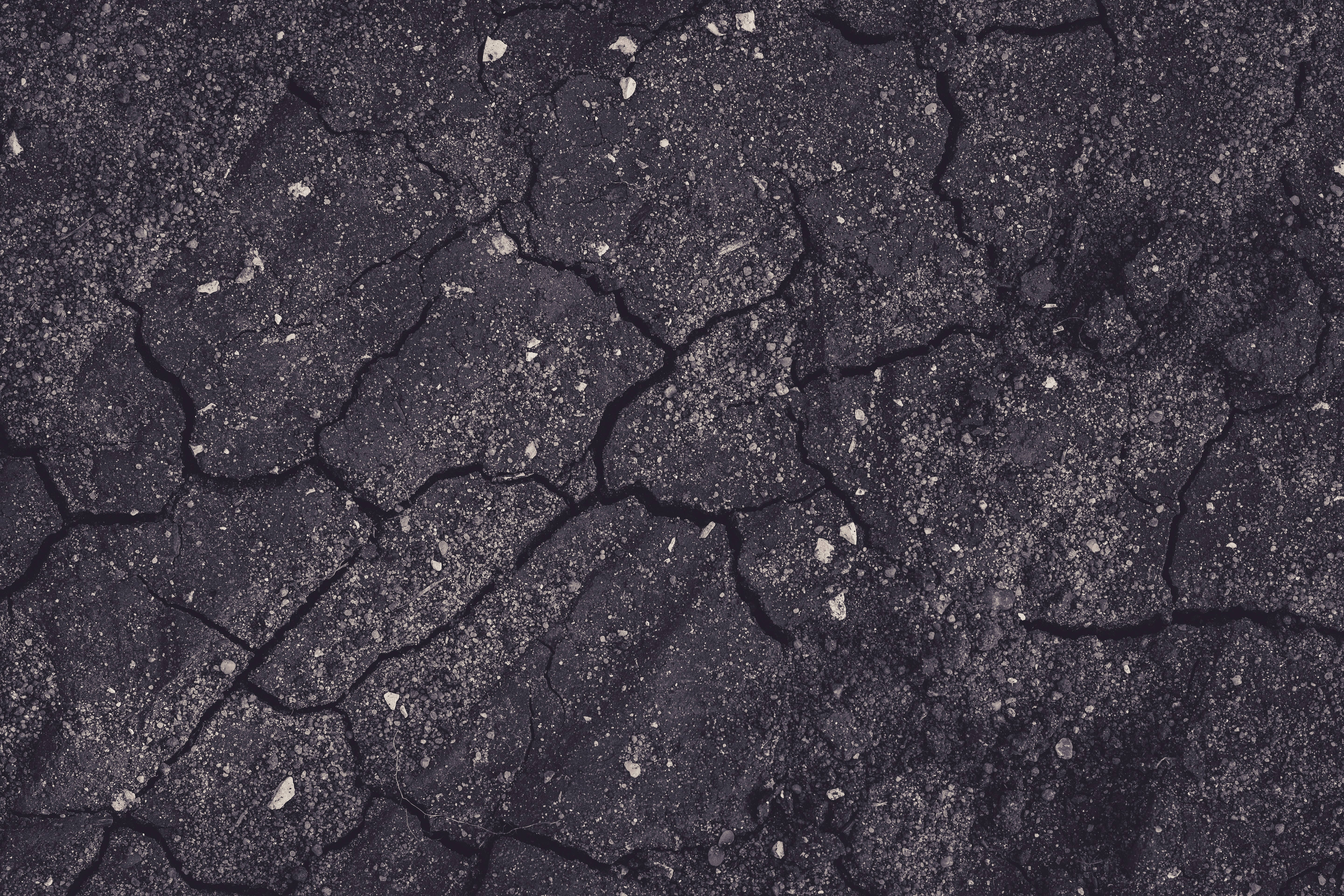 cracked asphalt pavement, scattered gravel, deep fissures, 5K Desktop Wallpaper