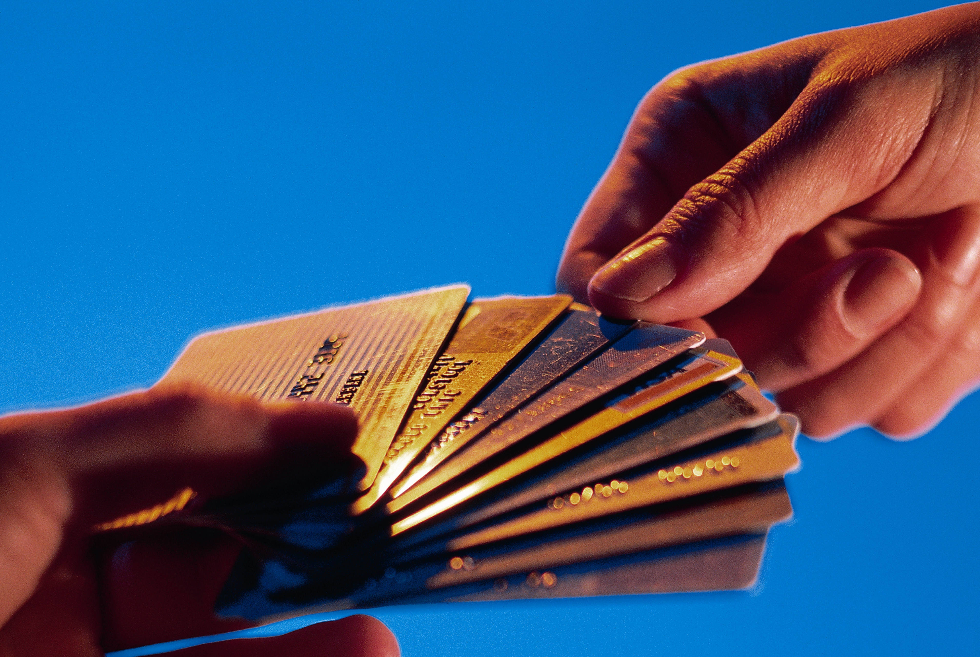 credit cards, vibrant blue background, warm lighting, 2K Desktop Wallpaper