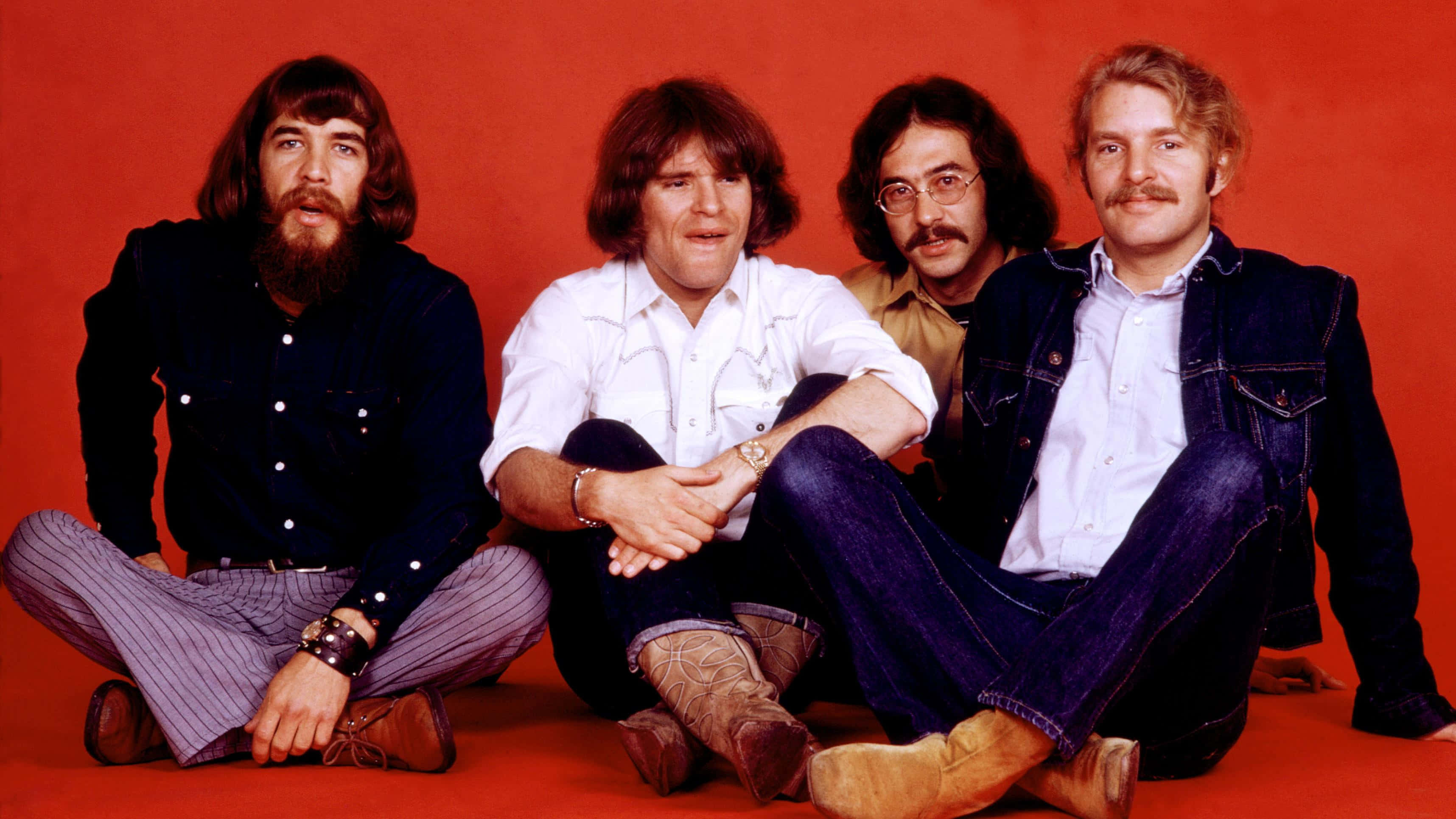 Creedence Clearwater Revival, 70s attire, vibrant red studio floor, 2K Desktop Wallpaper