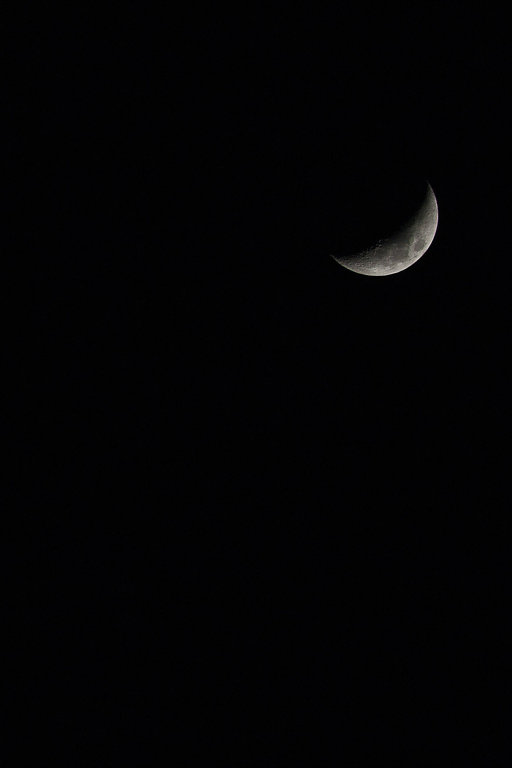 crescent moon, pitch-black night sky, cratered surface, 2K Phone Wallpaper