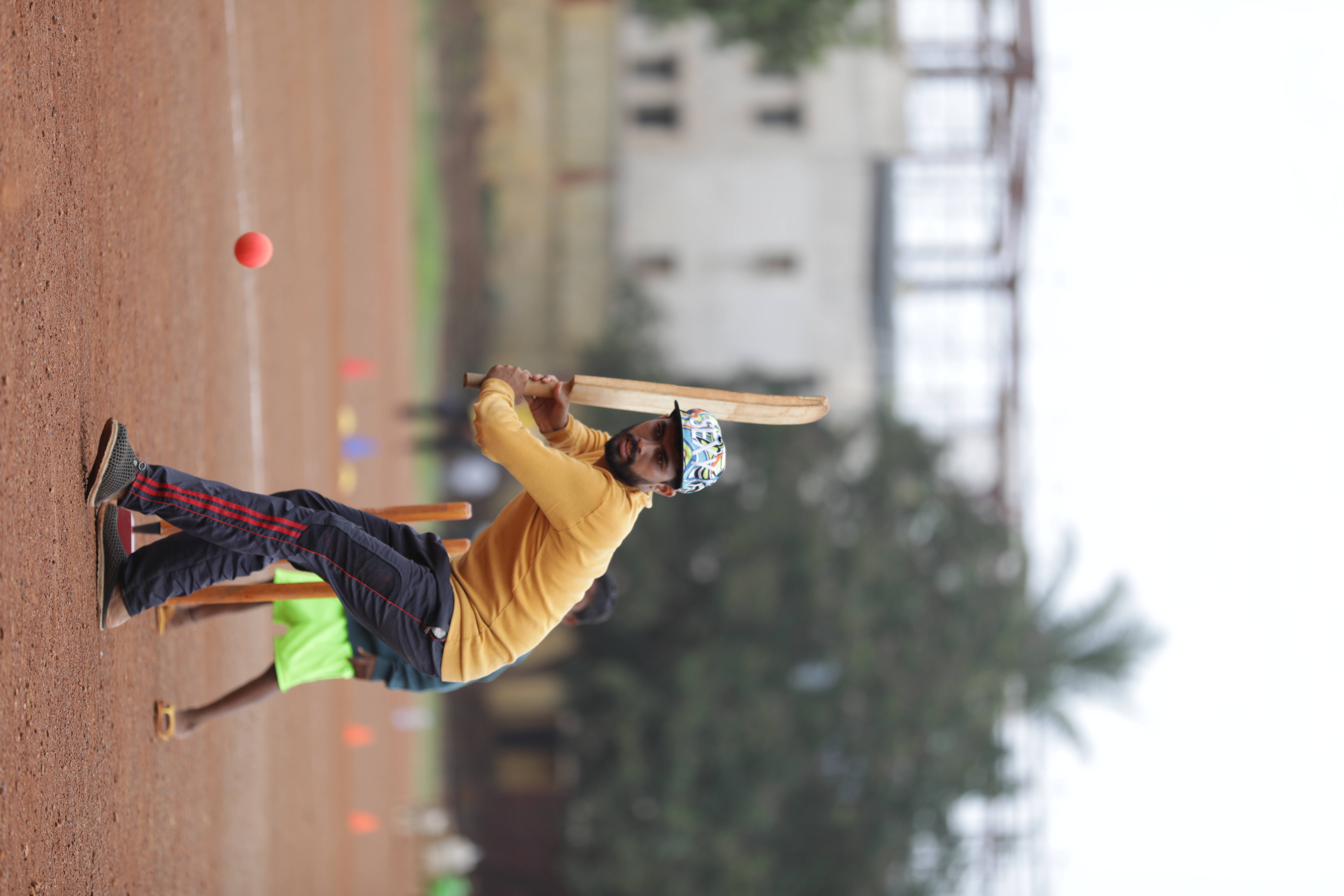 cricket player, yellow shirt, red ball, 5K Desktop Wallpaper