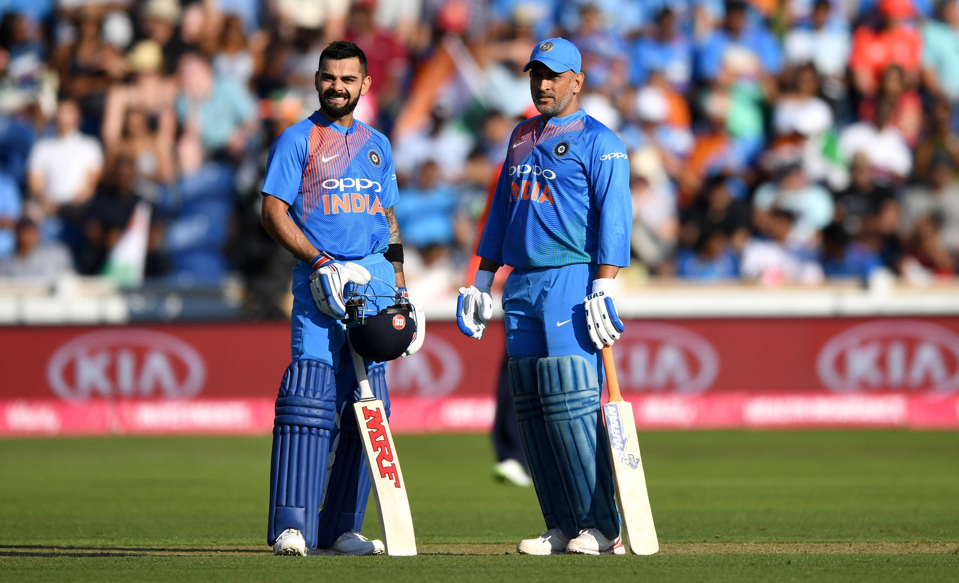 Indian cricket players, blue uniforms, green pitch, 4K Desktop Wallpaper
