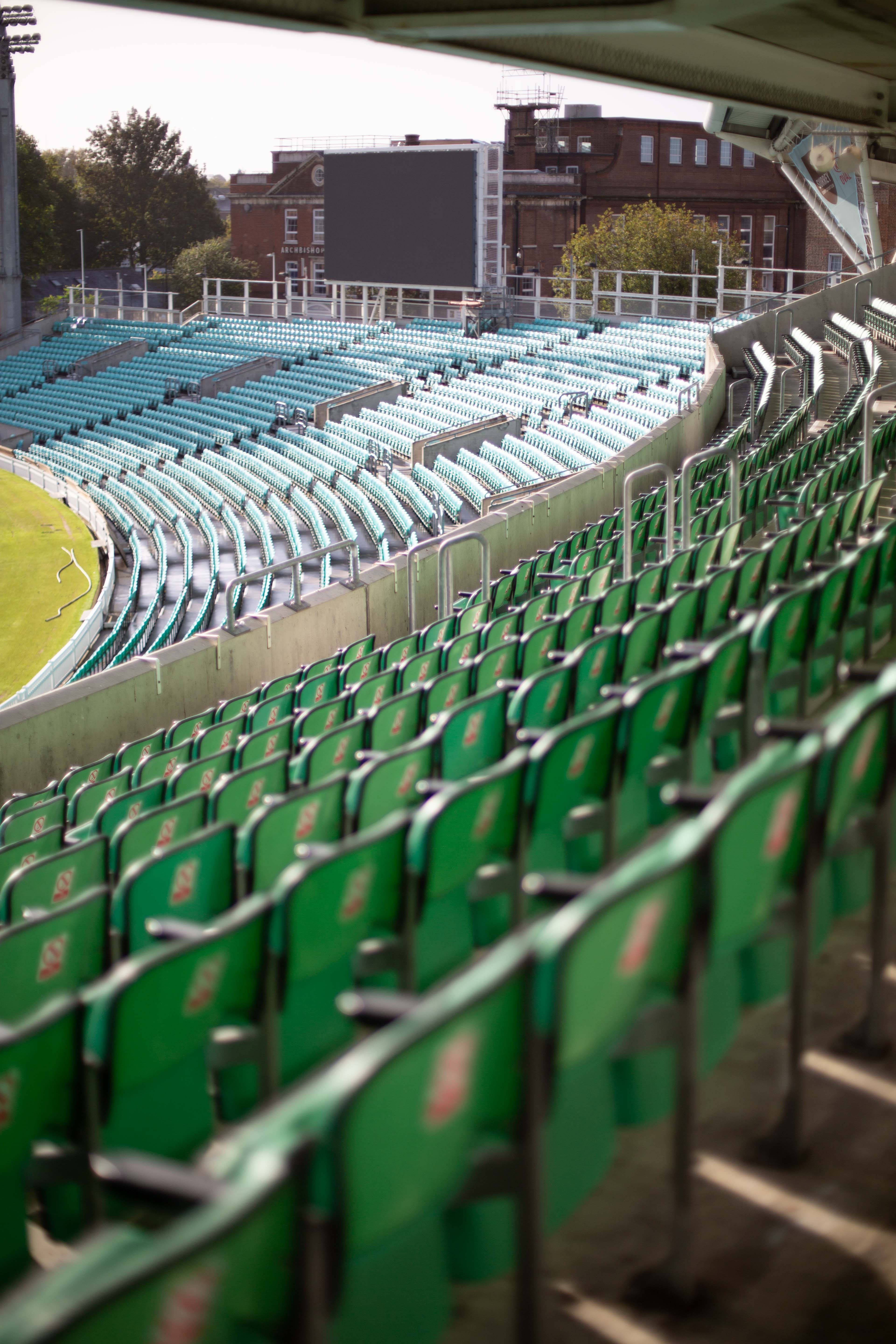 cricket stadium, green and teal stadium seats, sunlit grass field, 5K Phone Wallpaper