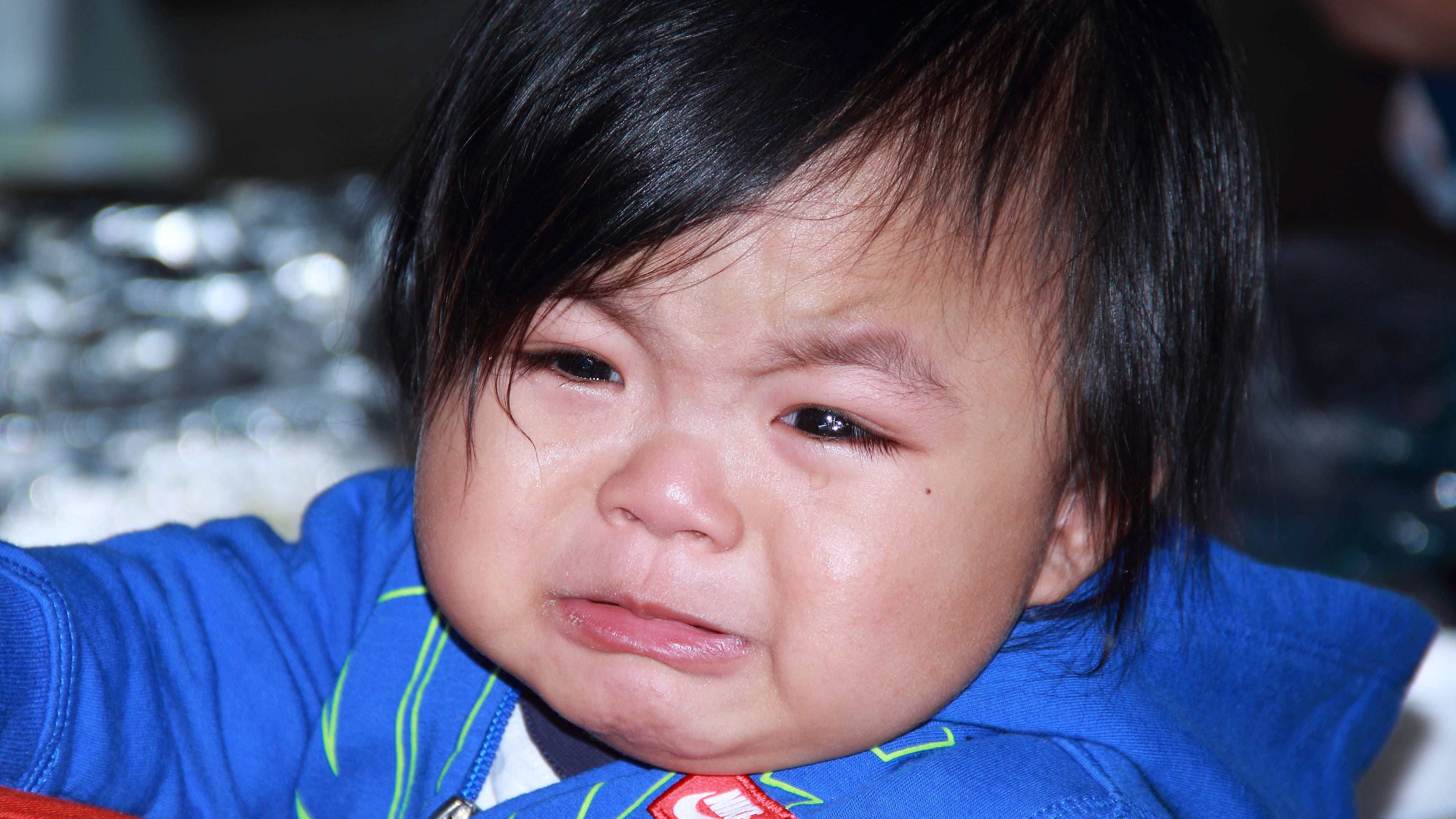 crying baby, dark hair, blue jacket, 4K Desktop Wallpaper