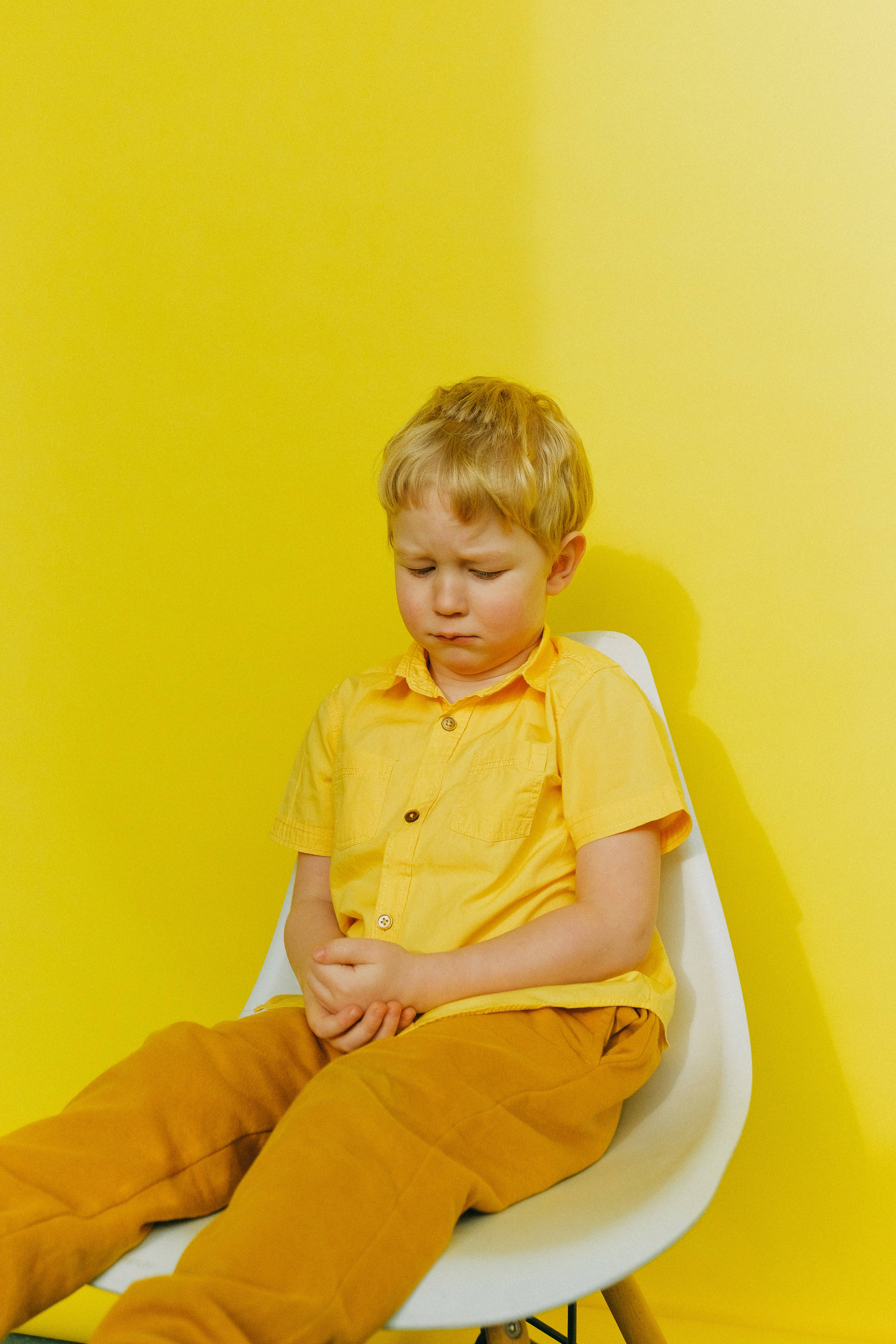 yellow attire, white chair, vibrant yellow wall, 5K Phone Wallpaper
