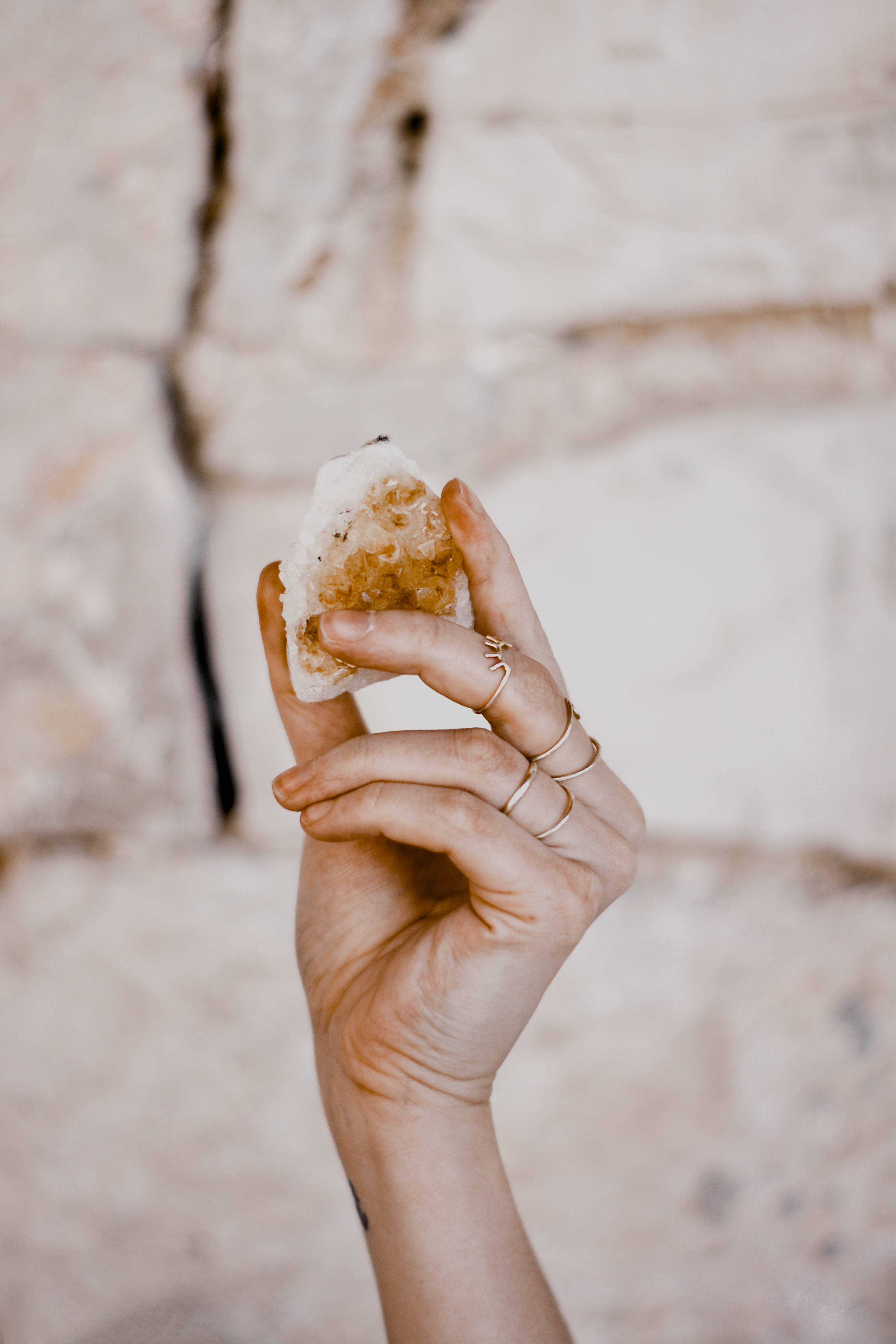 spiritual smoky quartz, geode crystal, soft blurred stone wall background, 5K Phone Wallpaper
