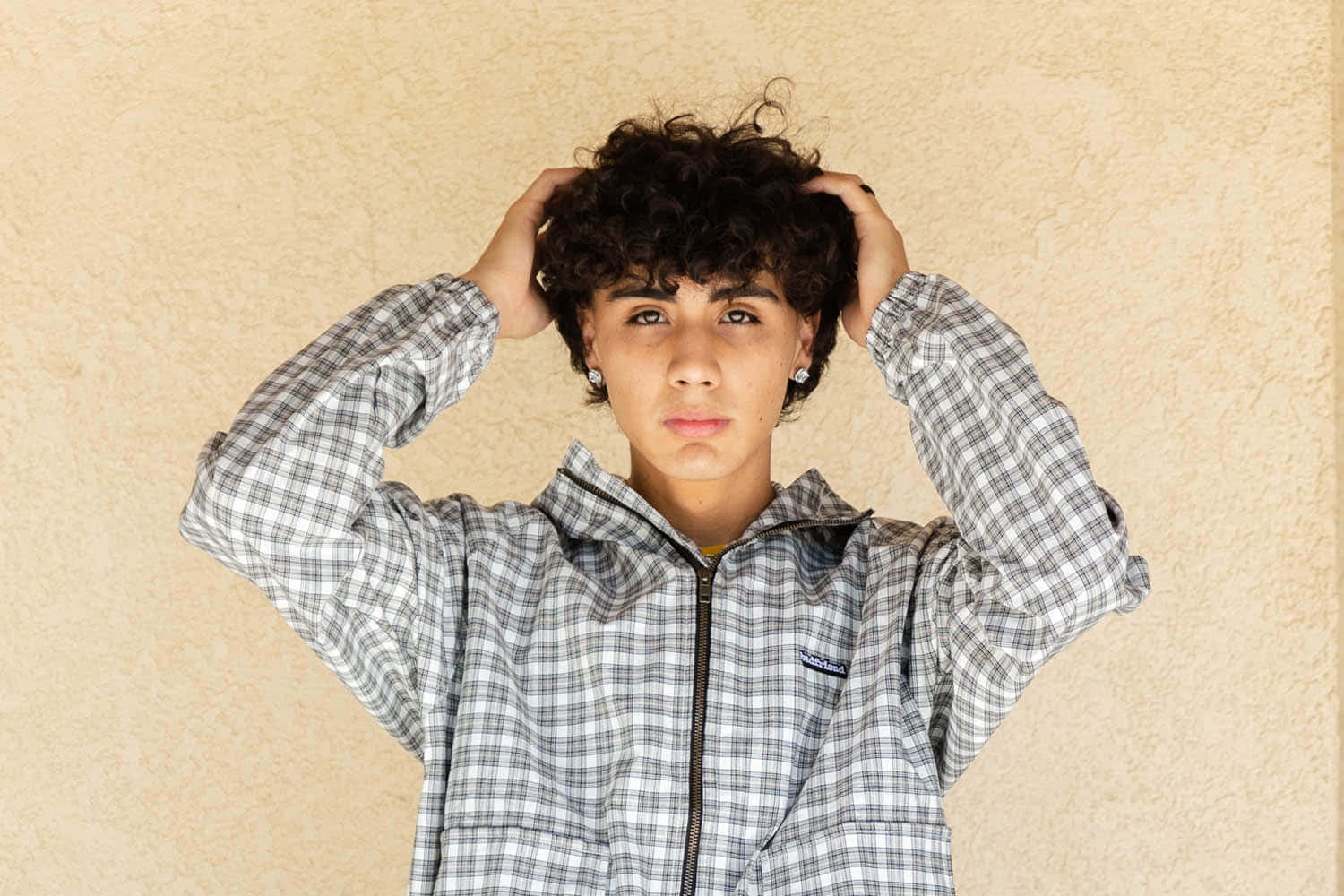 curly dark hair, plaid jacket, textured beige wall, HD Desktop Wallpaper