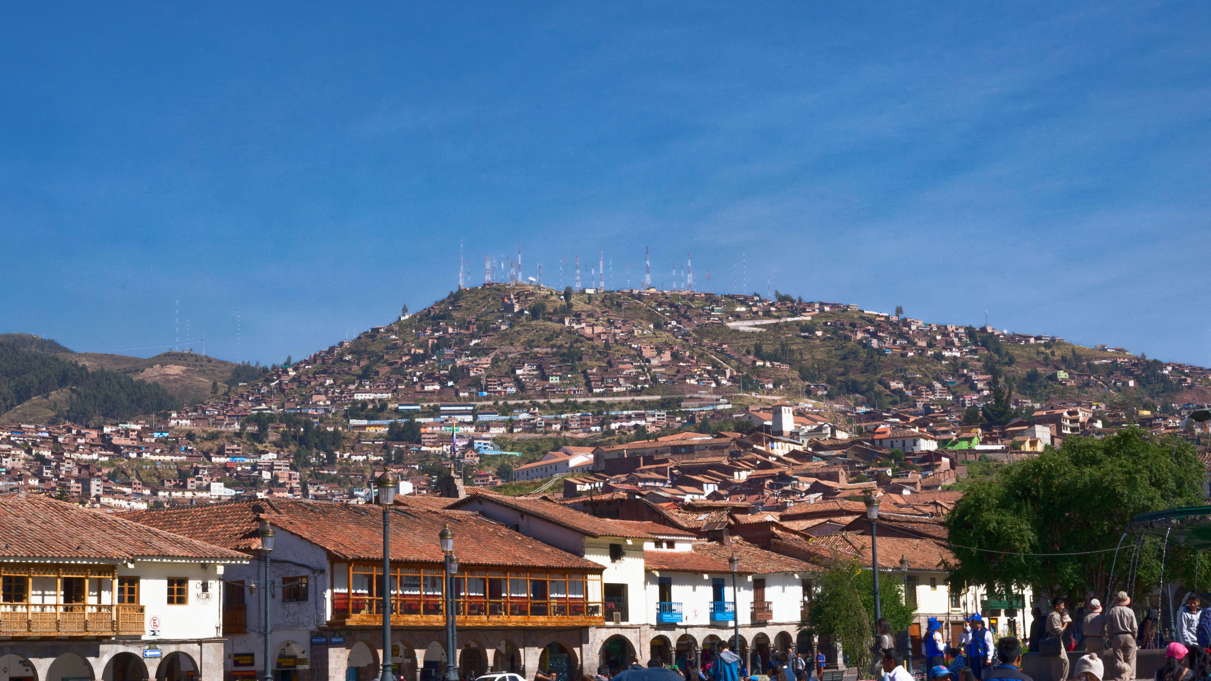Cusco Peru, terracotta-roofed buildings, sunlit mountain, 4K Desktop Wallpaper