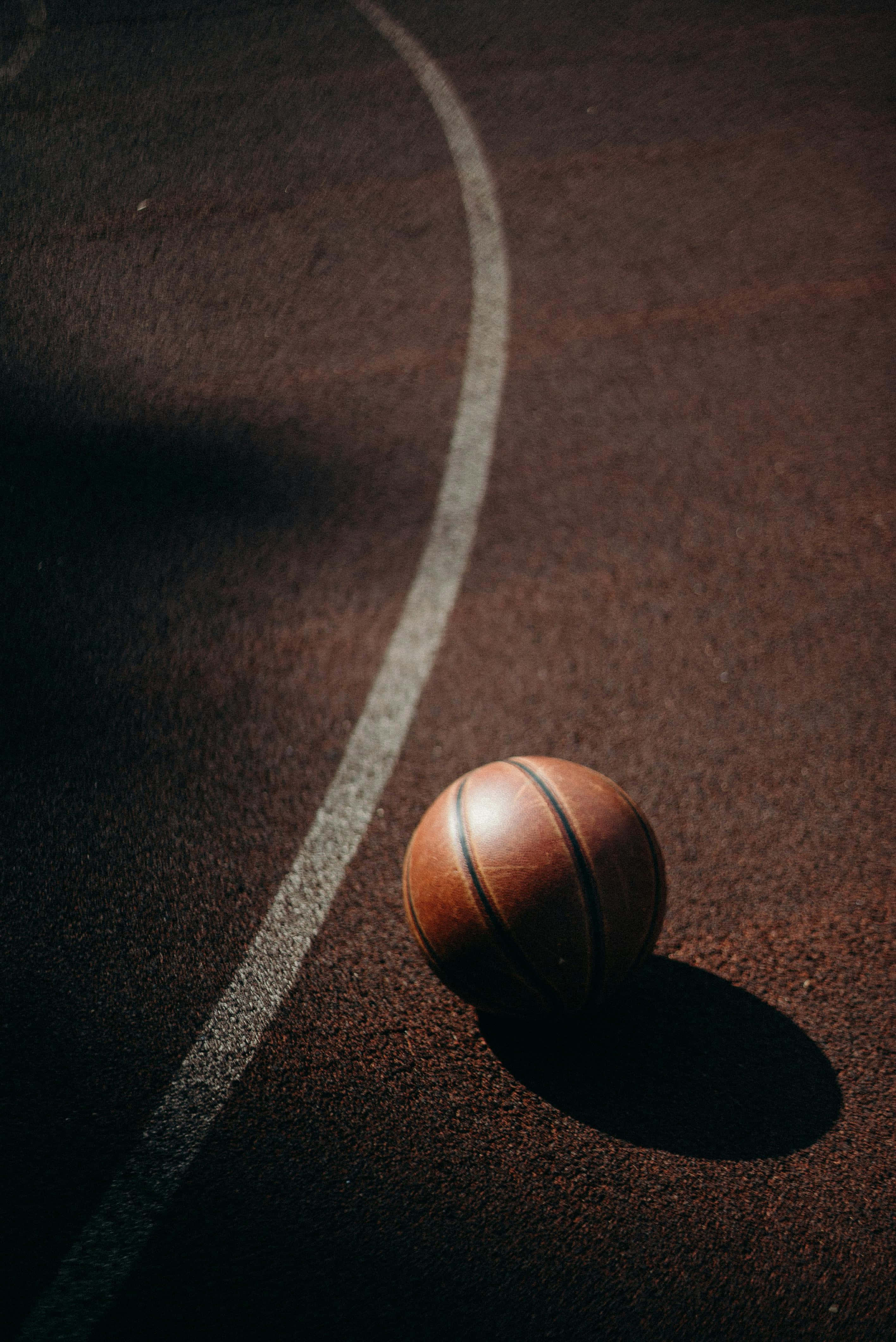 solitary basketball court, worn leather basketball, sunlit outdoor court, 4K Phone Wallpaper