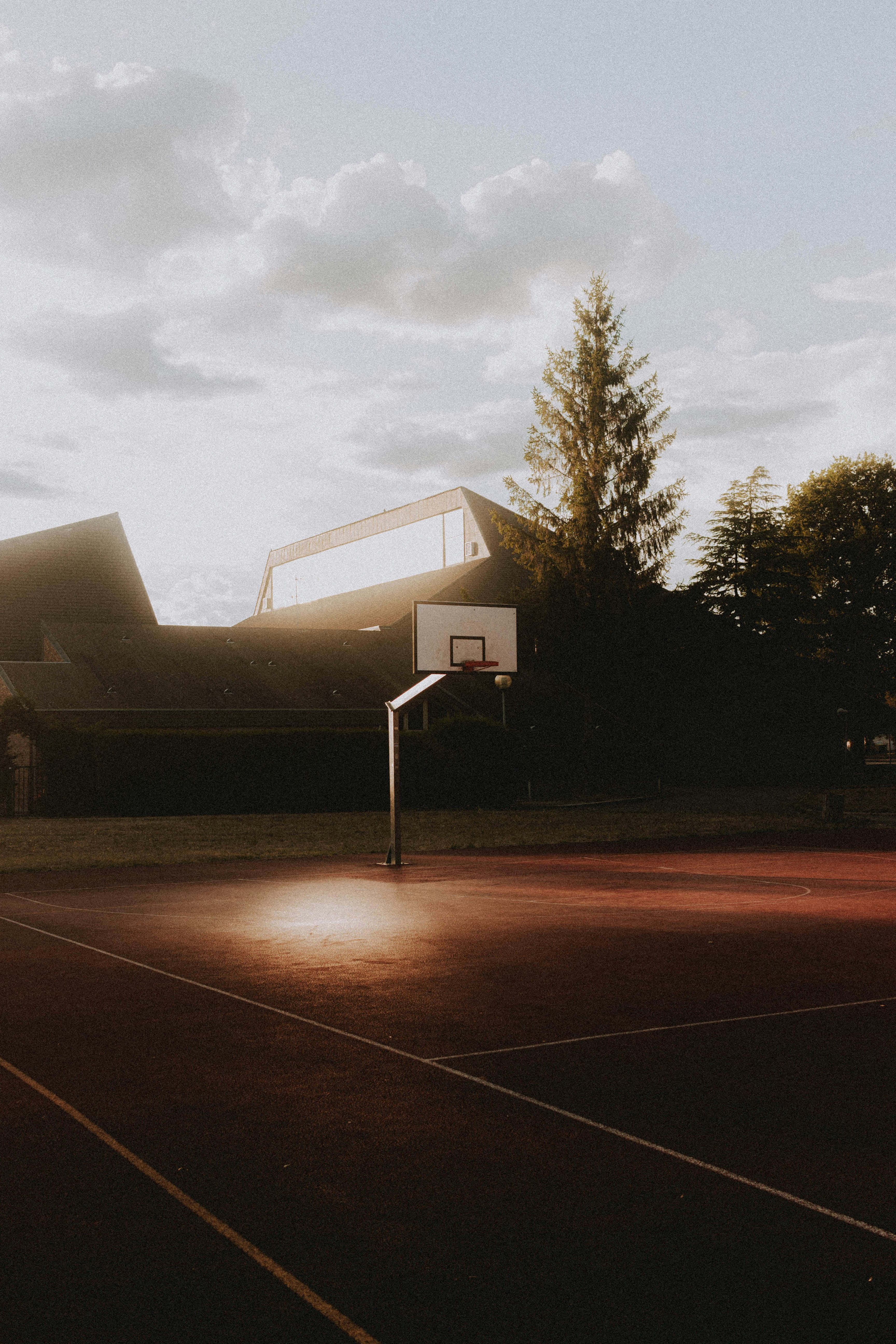sunset basketball court, warm sunset light, modern buildings, 5K Phone Wallpaper