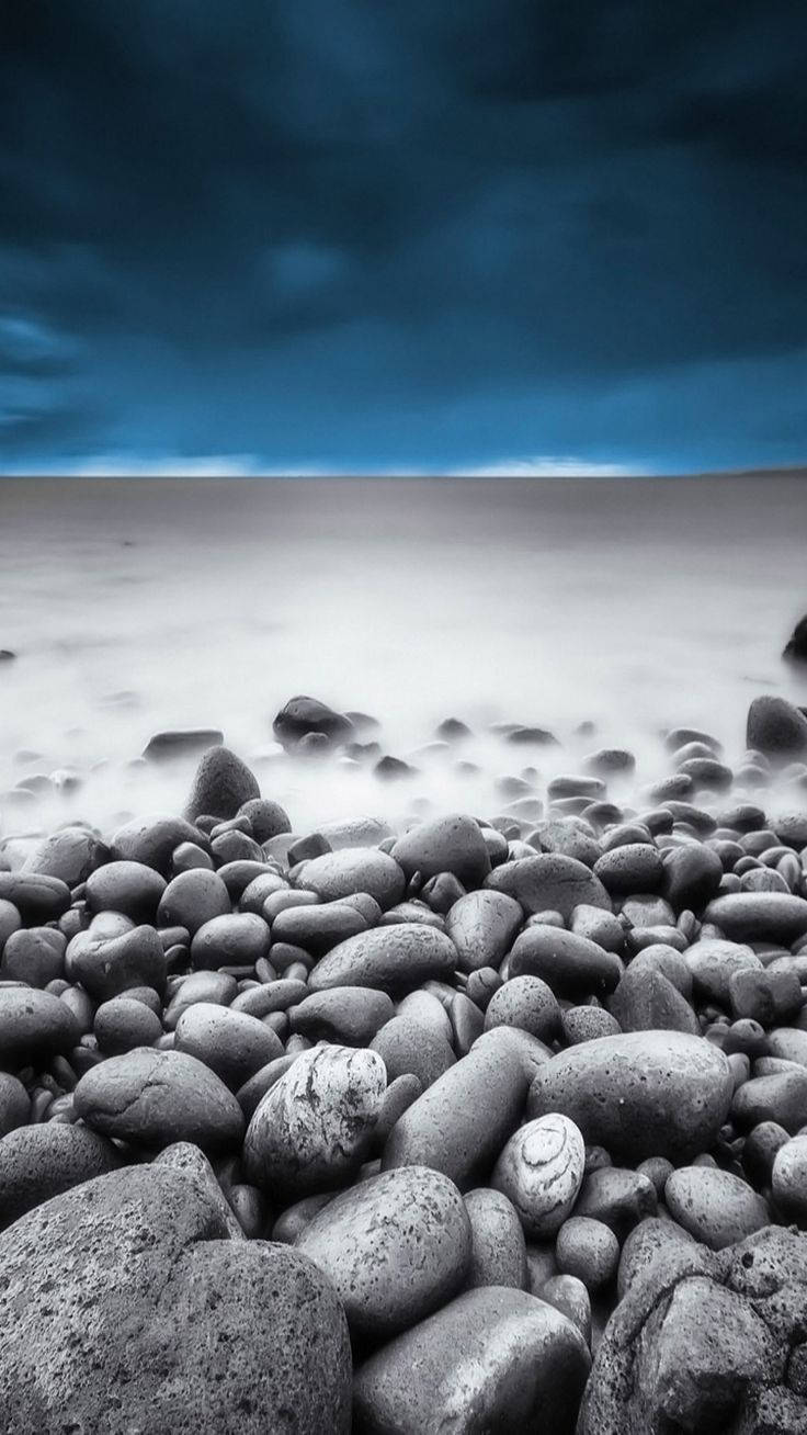 smooth gray pebbles, misty shoreline, dramatic deep blue sky, HD Phone Wallpaper