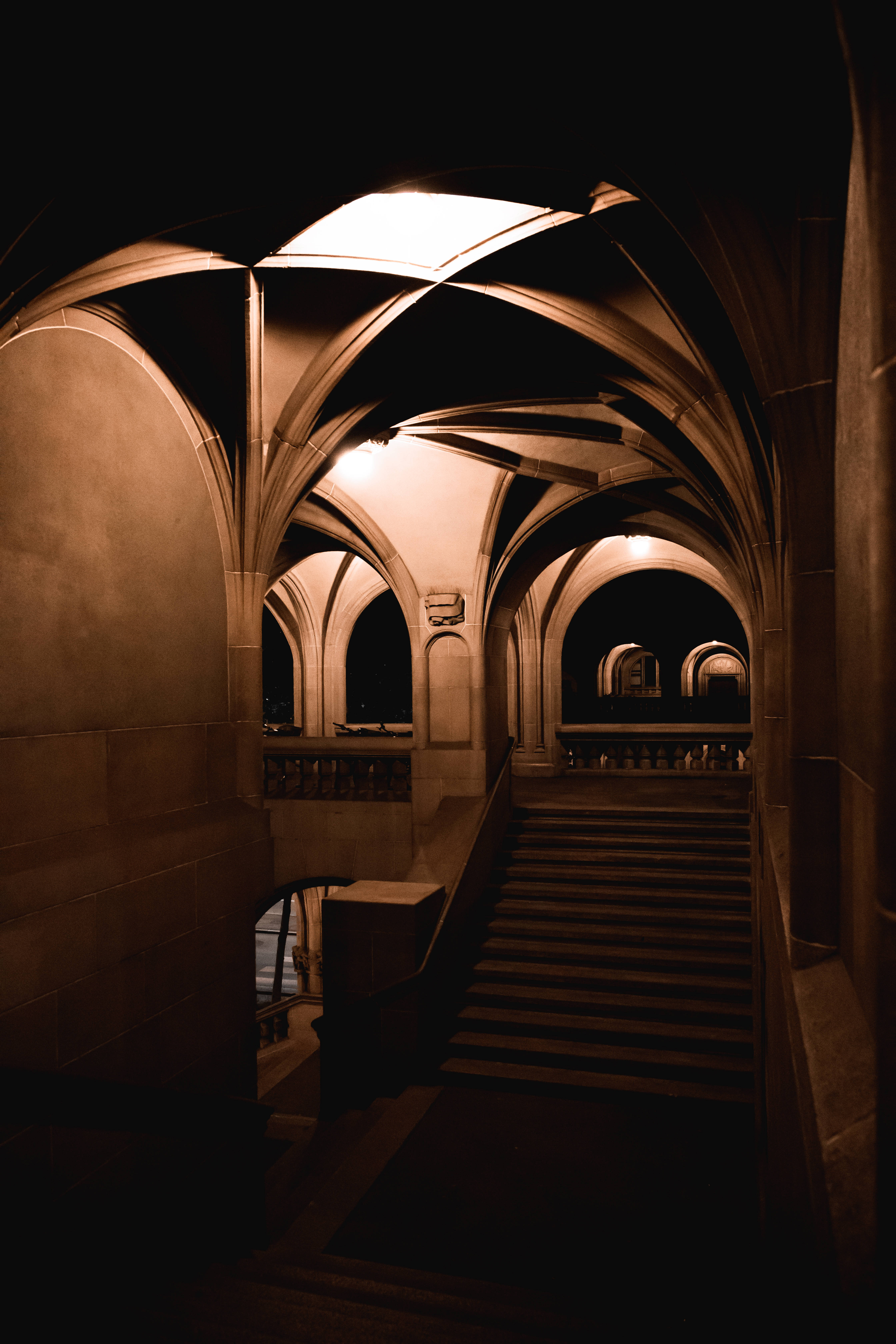 Cute Black Crypt Aesthetic, stone staircase, warm glowing arches, 5K Phone Wallpaper