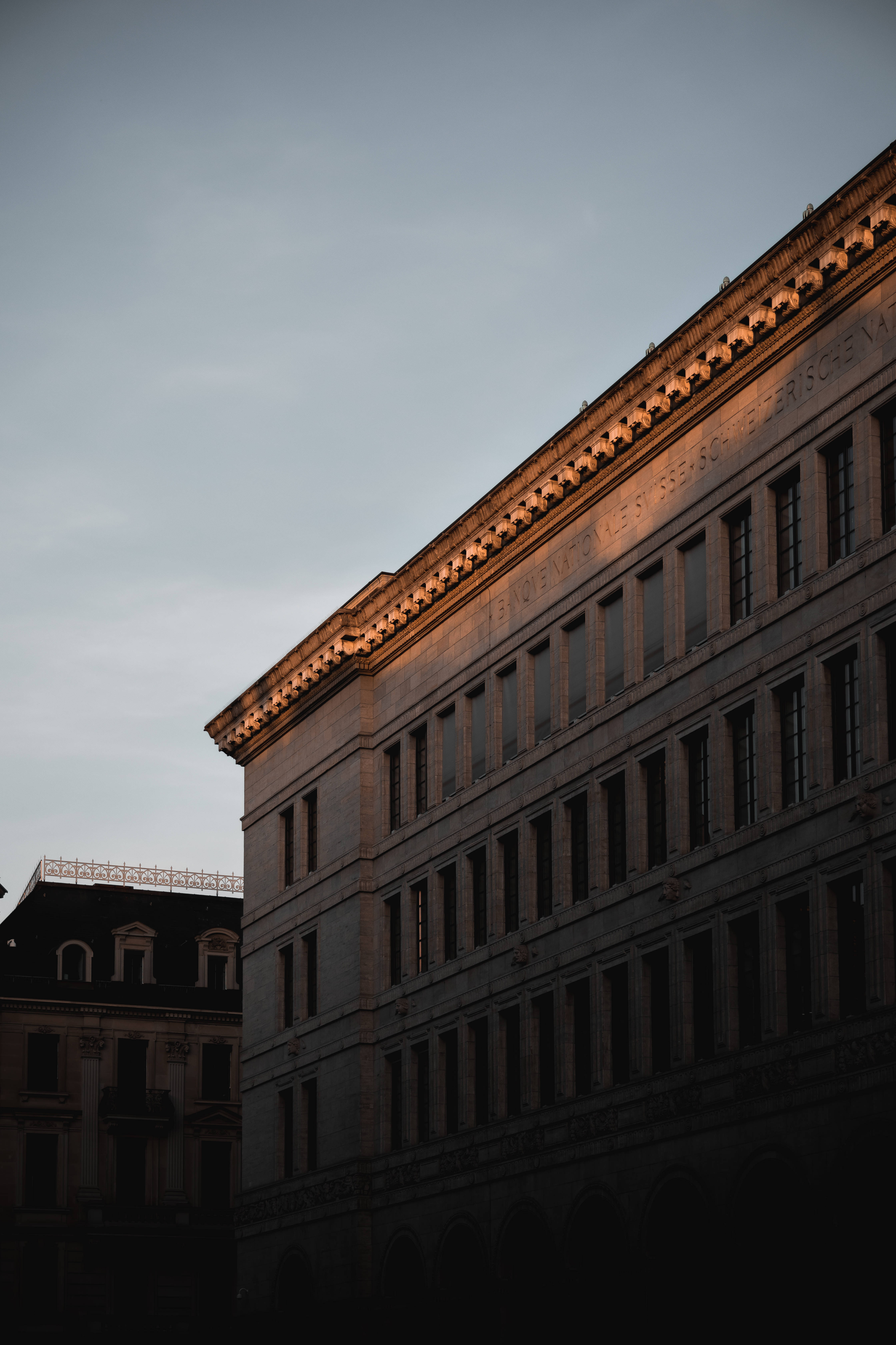neoclassical building facade, golden hour light, twilight sky, 5K Phone Wallpaper