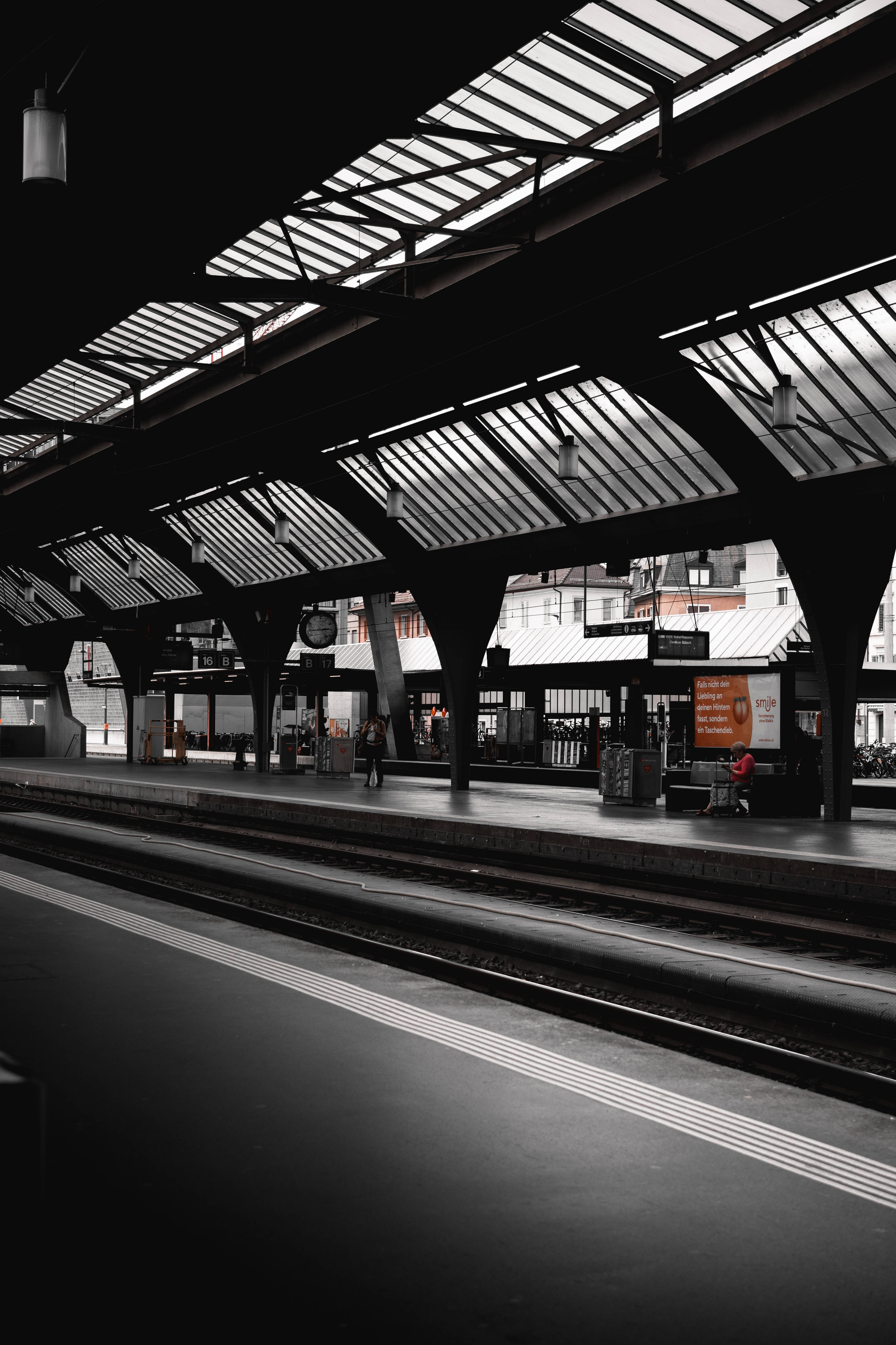 black and white train station platform, geometric skylights, sharp shadows, 5K Phone Wallpaper
