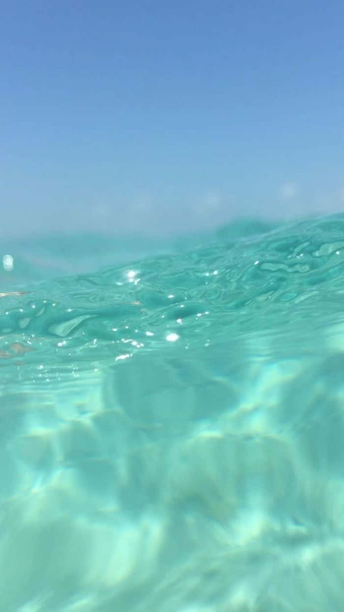 Cute Blue iPhone, turquoise ocean waves, clear blue sky, SD Phone Wallpaper