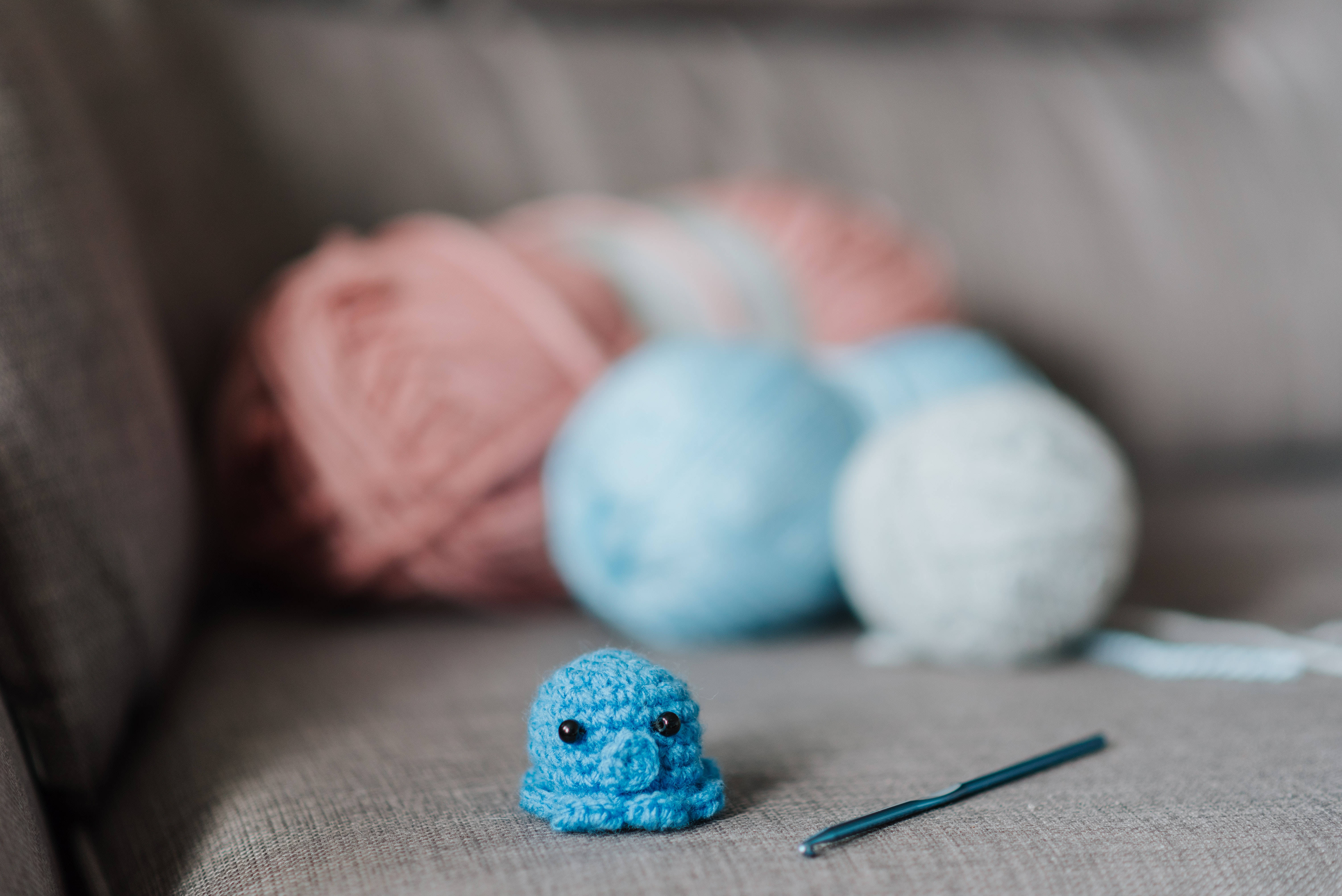cute knitted blue octopus, blue crocheted creature, gray couch, 5K Desktop Wallpaper