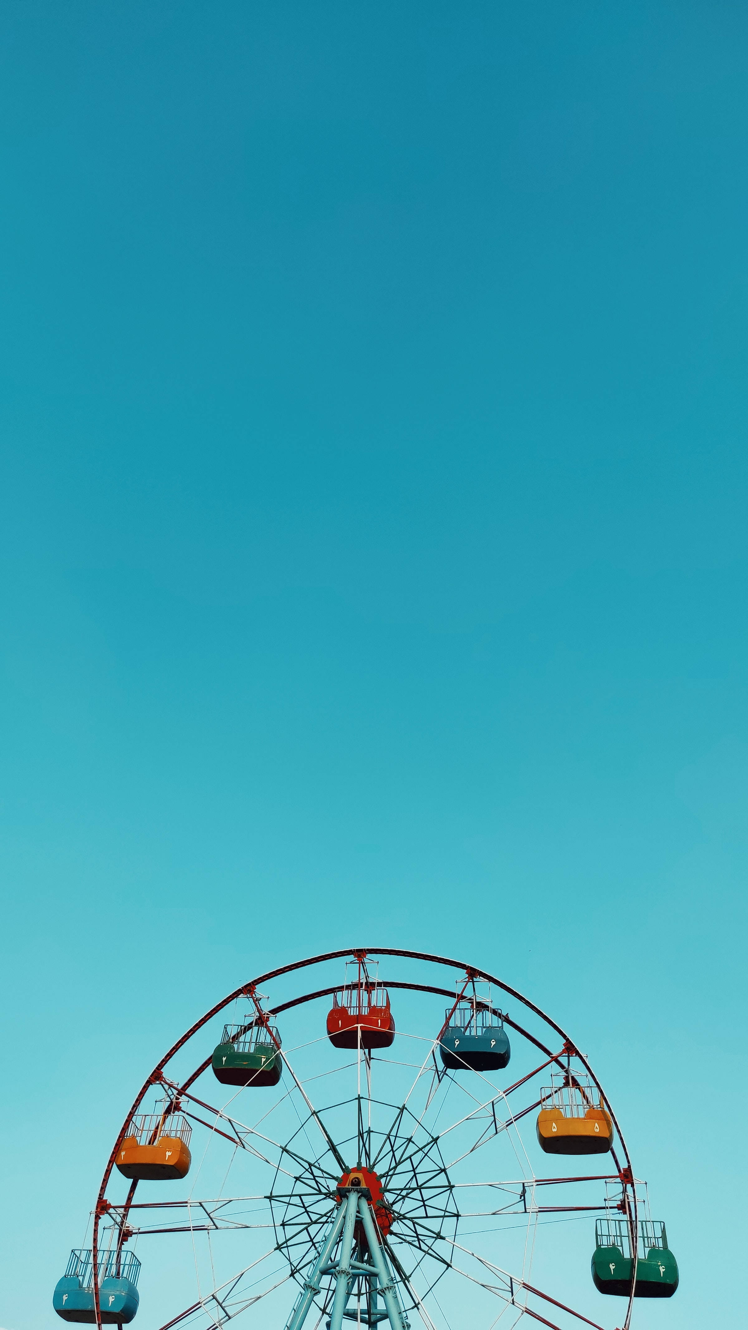 cute blue aesthetic, minimalist ferris wheel, red orange and teal gondolas, 4K Phone Wallpaper