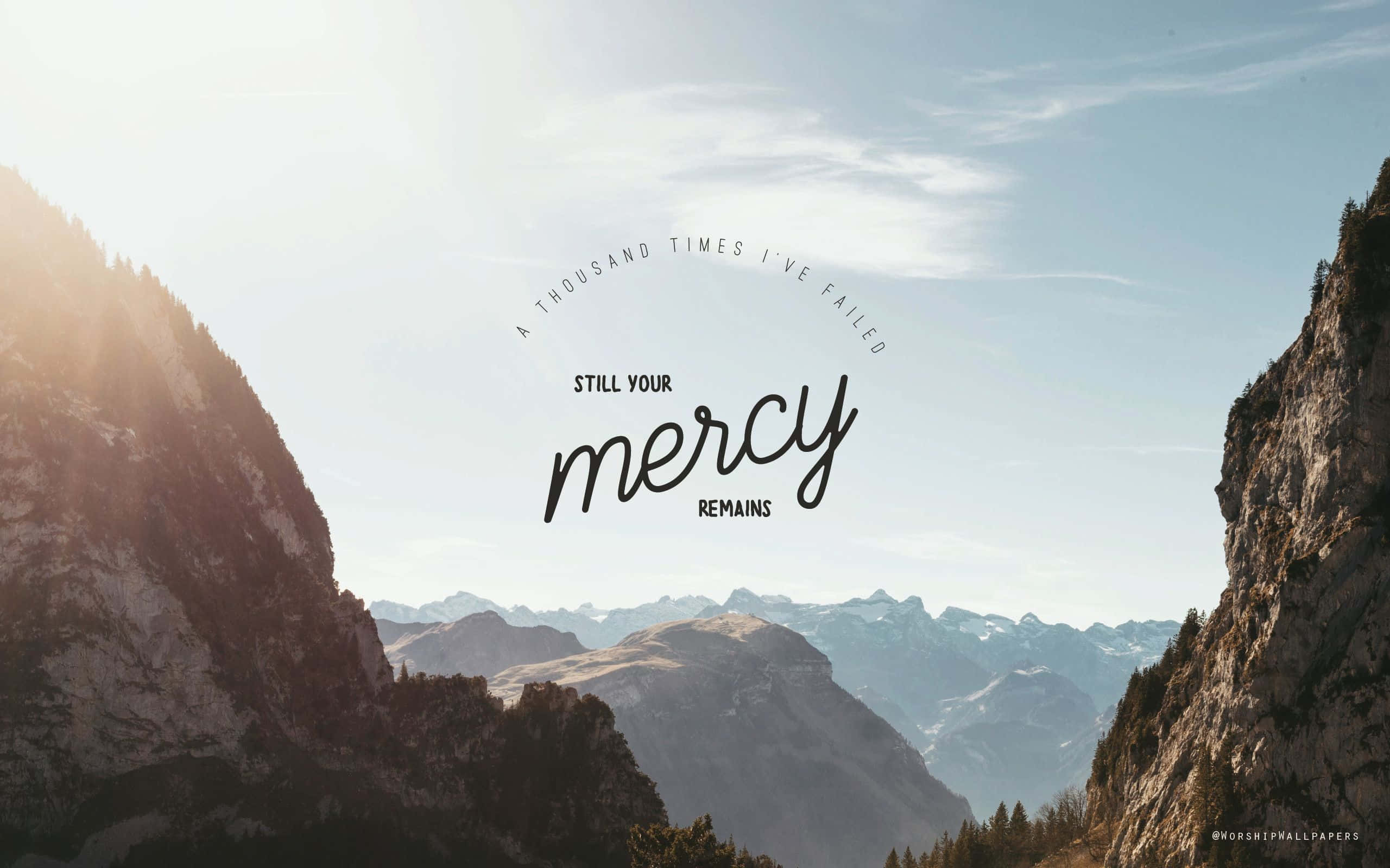Sunlit mountain valley, rugged cliffs, inspirational text overlay, 2K Desktop Wallpaper